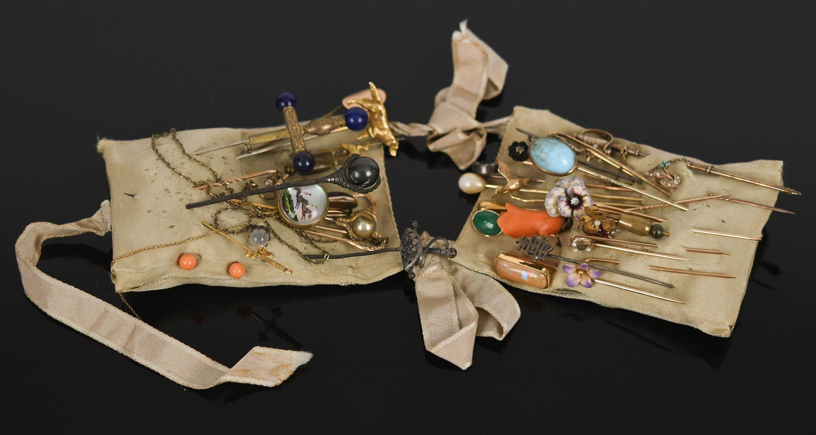 SOME GOLD ANTIQUE STICK PINS.: A variety of antique stick pins, including: 19, gold-filled, base metal or silver, dog, glass, flowers, crosses, swords, coral and more; 17, 10-14k yellow gold (tested, mostly 14k, one pin stem is