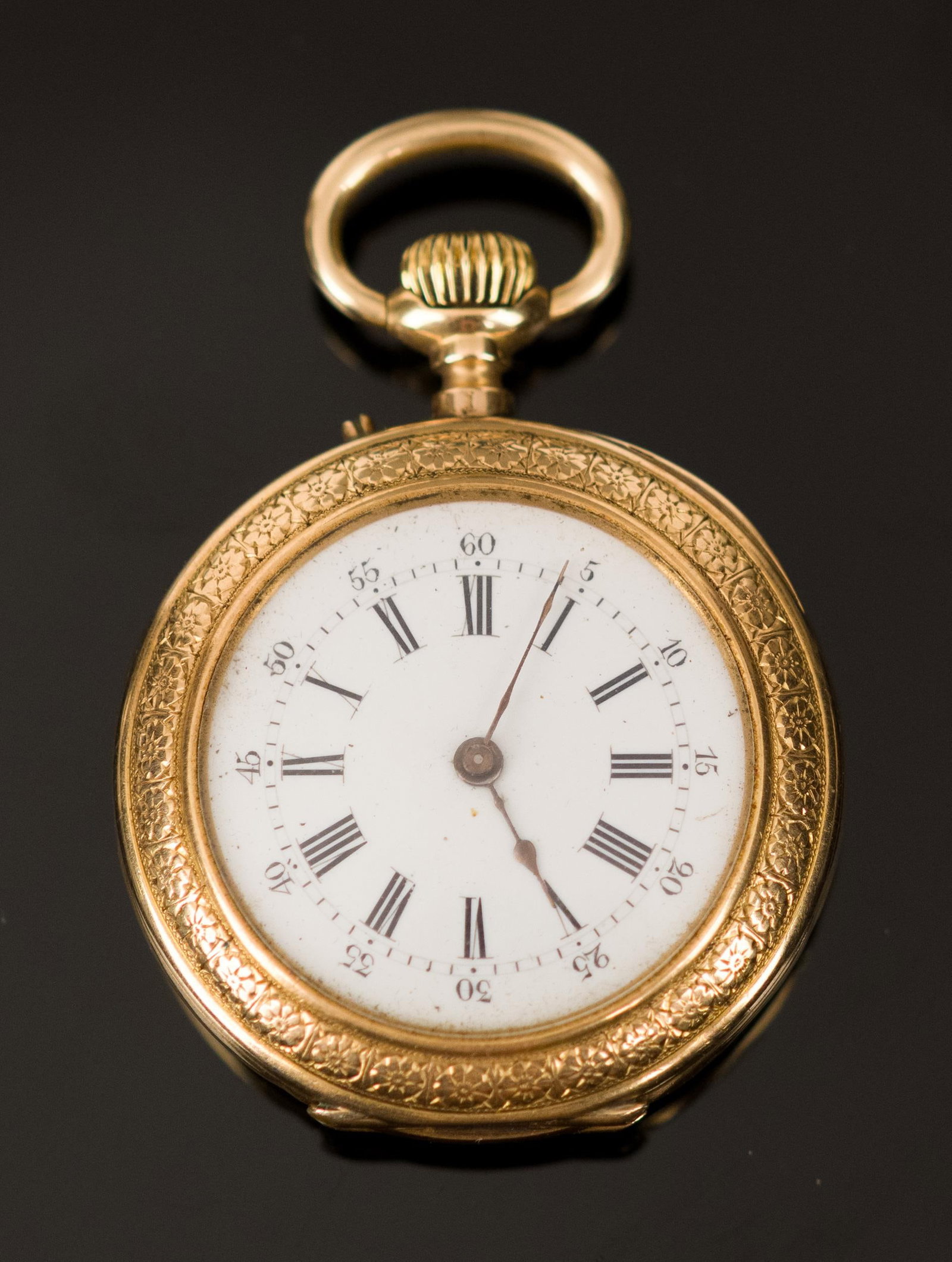 ANTIQUE FRENCH 18K GOLD OPEN FACE PENDANT WATCH.: An antique, ornately engraved, 18k yellow gold (stamped w/ French hallmark), open face pendant watch, 33mm case, unnamed, 30 grams gross weight.