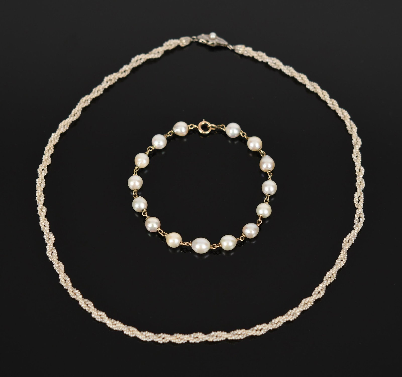 ANTIQUE SEED PEARL NECKLACE AND PEARL BRACELET.: An antique, twisted, seed pearl necklace with a 14k white gold (tested) pearl clasp with small diamond chips, 17 inches long; 14k yellow gold (stamped), cultured pearl bracelet, 6 - 6.5mm, near to off