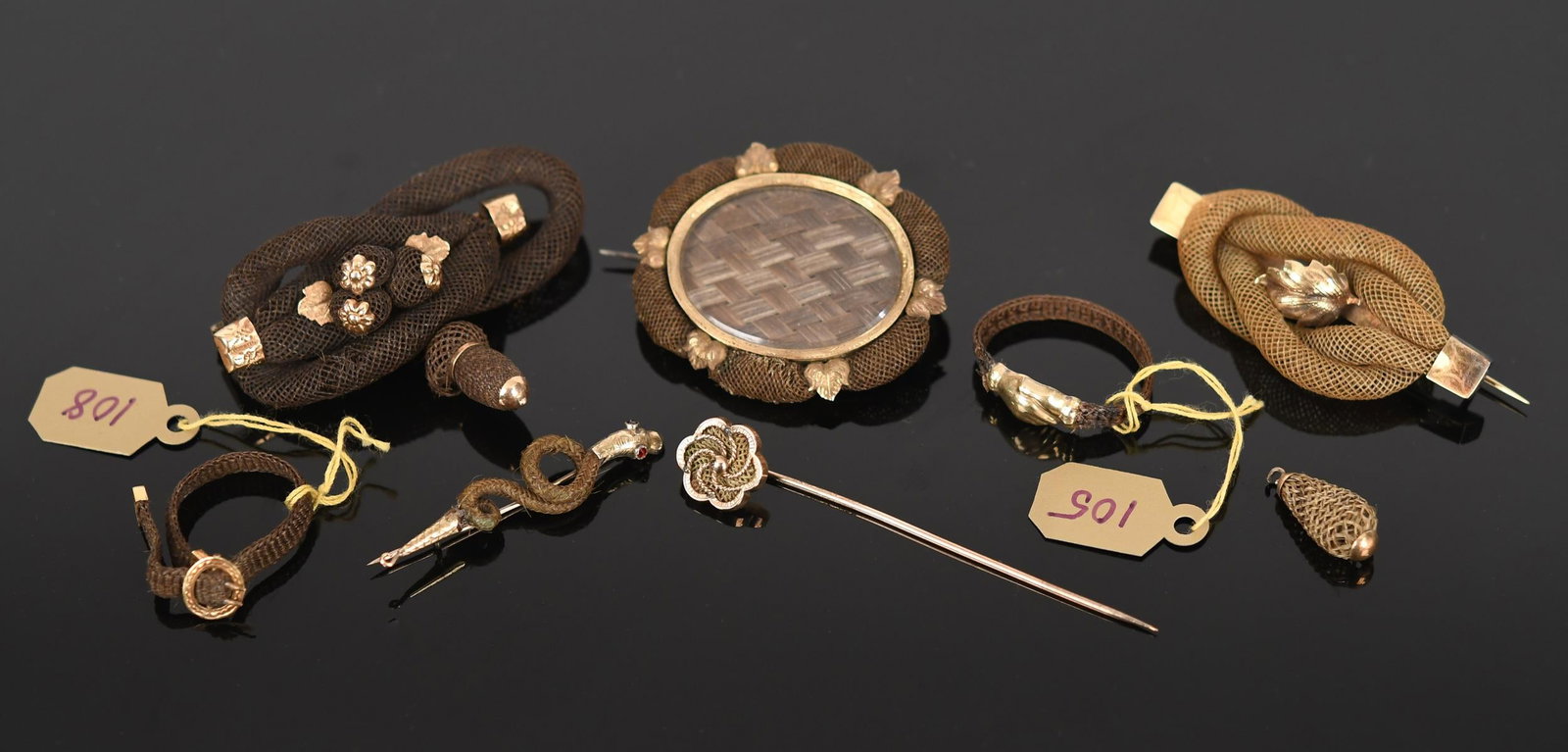 VICTORIAN 10K-15K GOLD HAIRWORK JEWELRY.: Victorian 10-15k yellow gold (tested), hairwork jewelry seven pieces, including:pin w/ 10k-14k backing, woven hair under glass, inscribed, I. Wales on reverse (on cover), 1 3/4”L, 9.2 grams gros