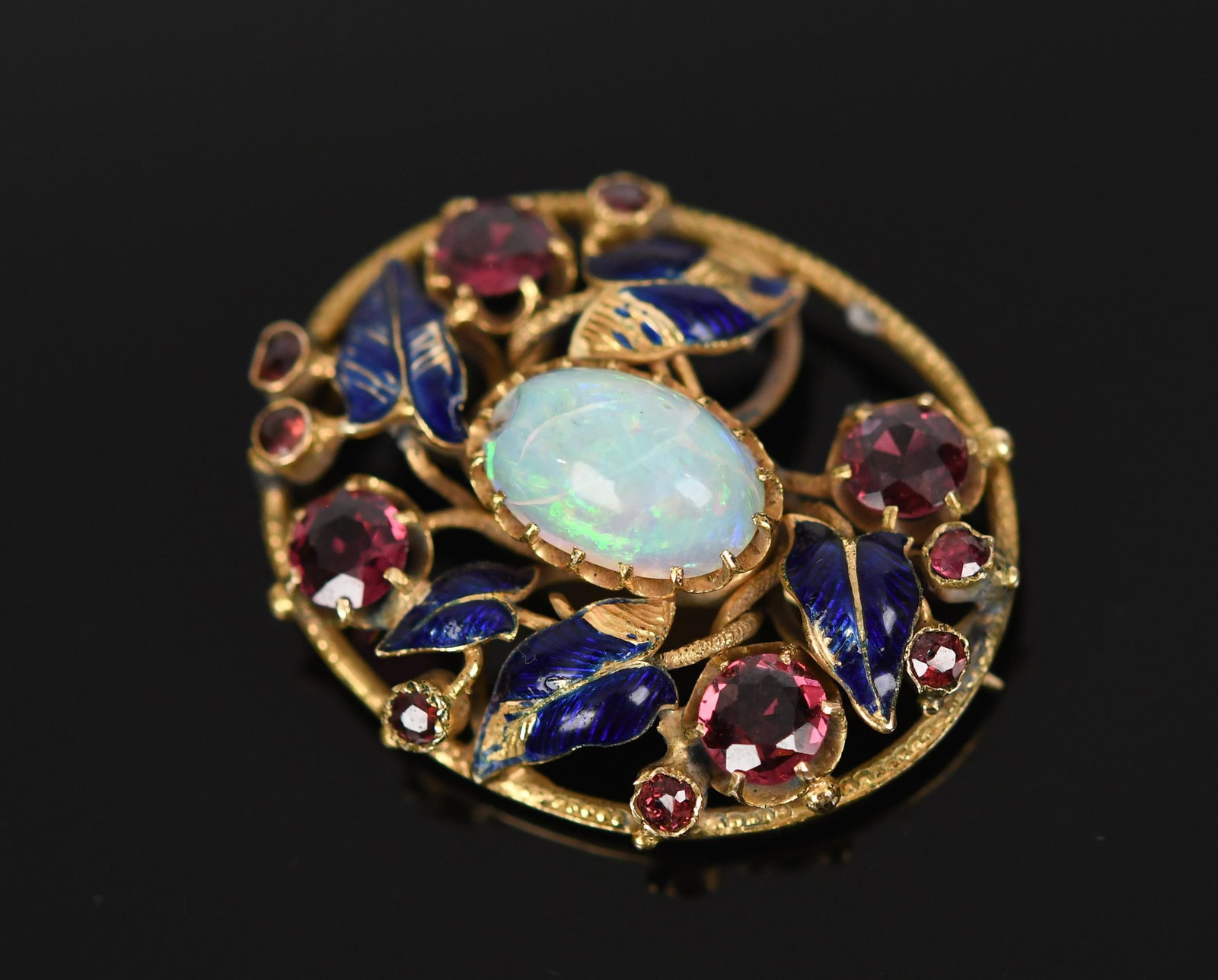 ANTIQUE 14K GOLD OPAL, TOURMALINE & ENAMEL PIN.: An antique, 14k yellow gold (tested), pin with blue enamel leaves, an approx. 3 ct. semi-transparent opal and approx. 2.5 ct. tw., faceted round, medium dark pink tourmaline, 1 5/16 inches long, 9.7 g