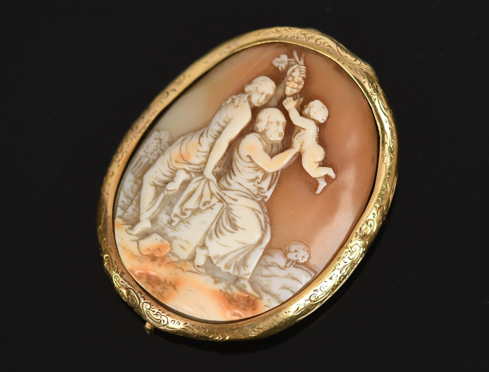 ANTIQUE 14-18K GOLD SHELL CAMEO PIN.: An antique, 14k-18k yellow gold (tested), shell cameo with a family scene, a hook on the bottom reverse for hanging, 2 1/2 inches long, 21.3 grams.