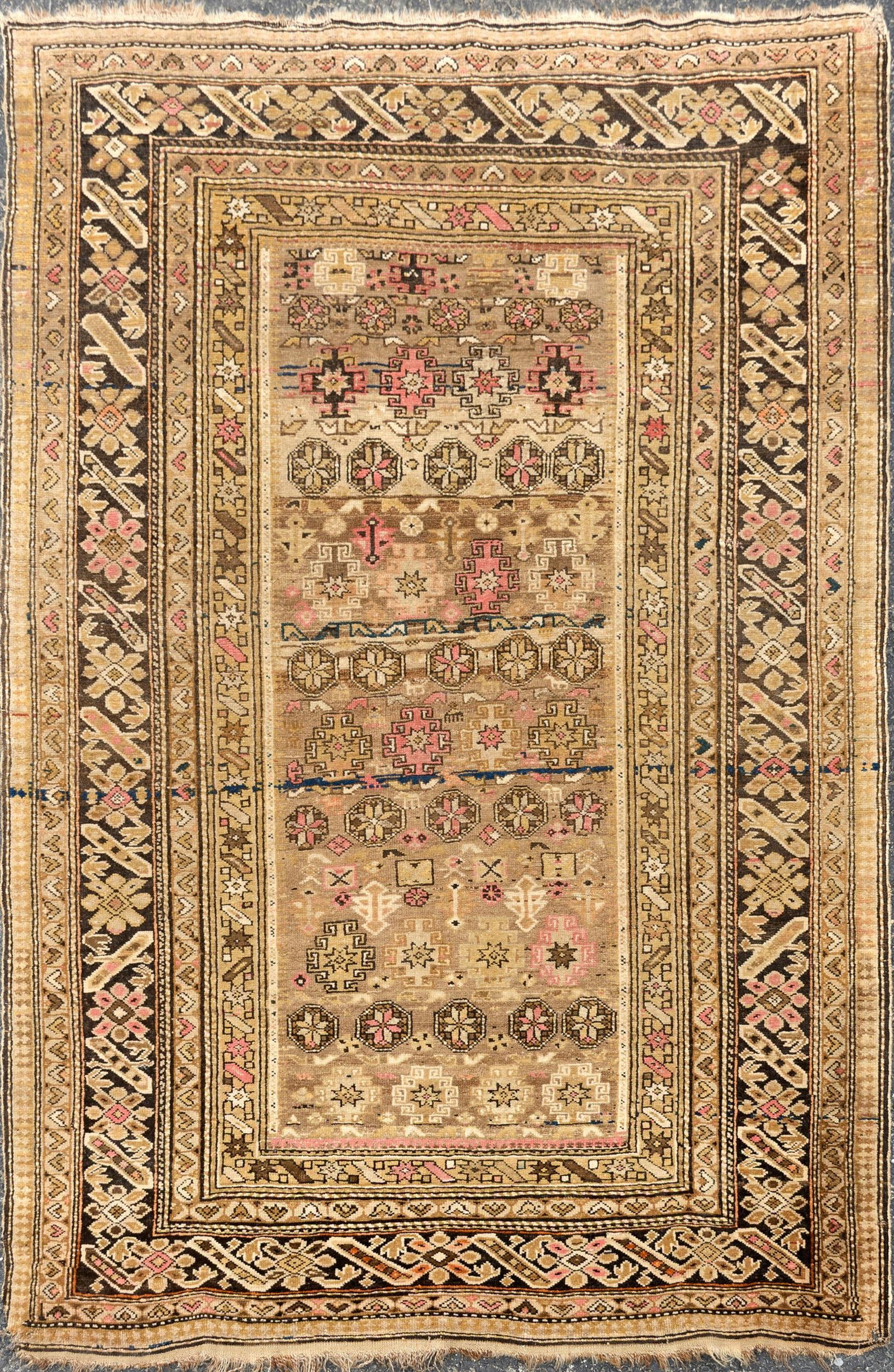 ANTIQUE IVORY FIELD ORIENTAL AREA RUG.: An antique Oriental hand-woven area rug with tan ground and pink and brown highlights. 4'1” x 6'. Provenance: the estate of Donald Roach Barrington RI.