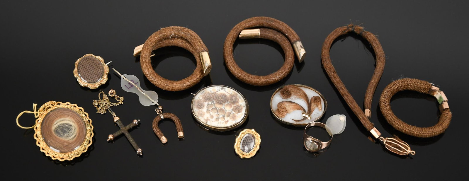 VICTORIAN GOLD, GOLD-FILLED & PINCHBECK HAIR JEWELRY.: Mid 19th century, gold or gold-filled (tested), hairwork, jewelry, 14k (tested) and some gold-filled:floral mounting, pin, reverse is damaged and has lead repairs;hairwork cross pendant (1 1/2”L
