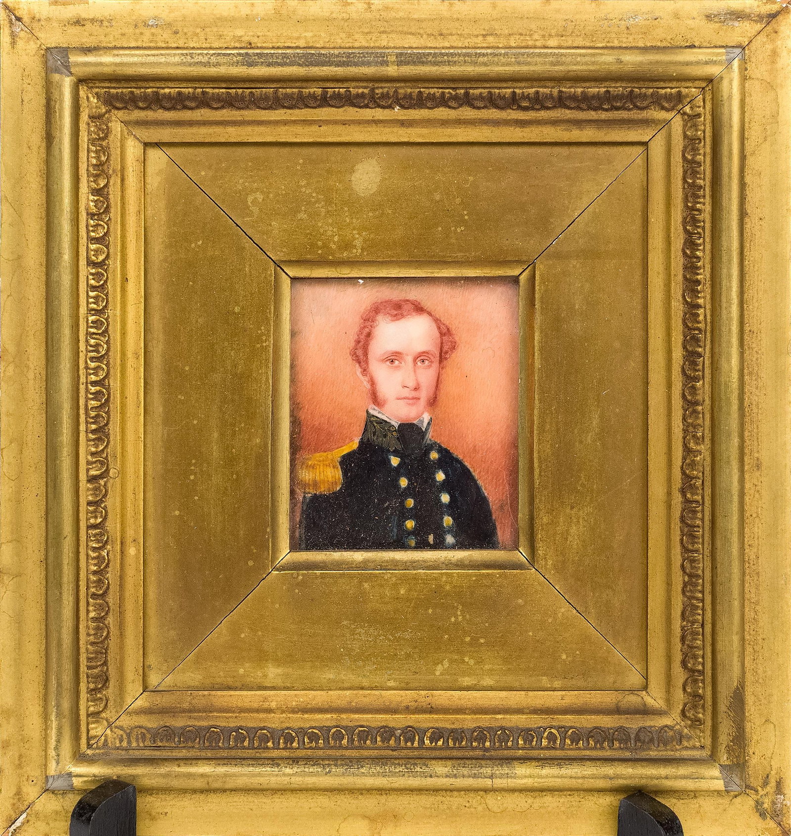 19TH C. MINIATURE PAINTING, BALTIMORE SOLDIER.: A ca. 1830 American miniature portrait painting of a man in uniform, in a period frame with label of M Barrett & Bro Carvers & Gilders of 82 Howard St of Saratoga Baltimore etc. Image 2.75” x