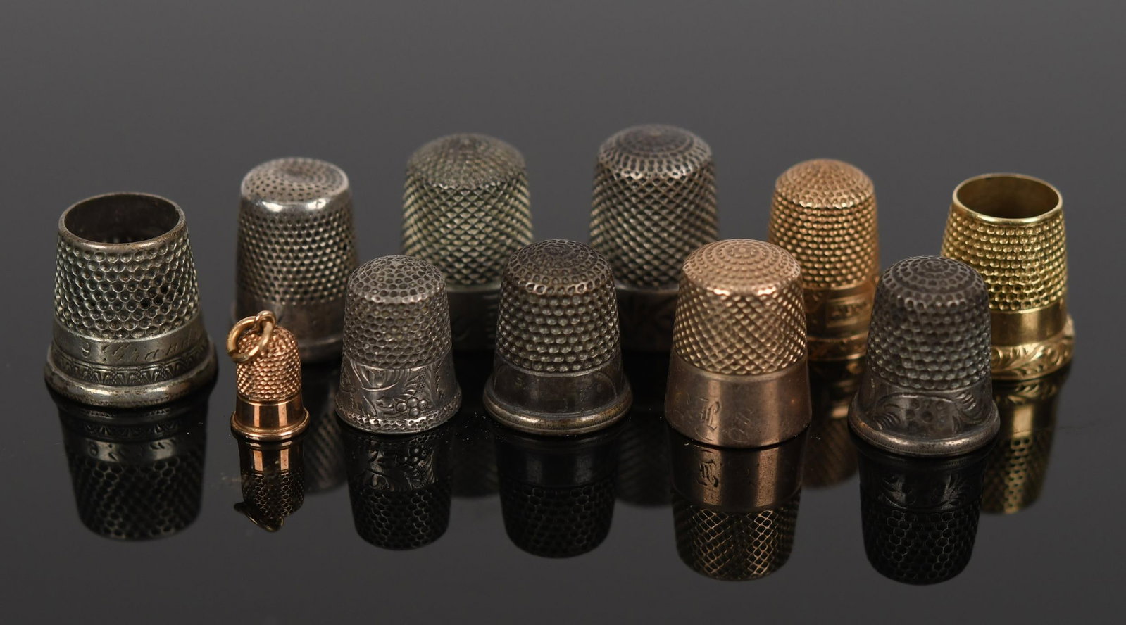 ANTIQUE STERLING SILVER & GOLD THIMBLES.: Antique thimbles of various sizes: 7, sterling silver (tested), .98 oz t, 3, 10k yellow gold (tested, one is a small charm), 8.7 grams and 1, 14k yellow gold (tested), 4.5 grams, for a total of 13.2