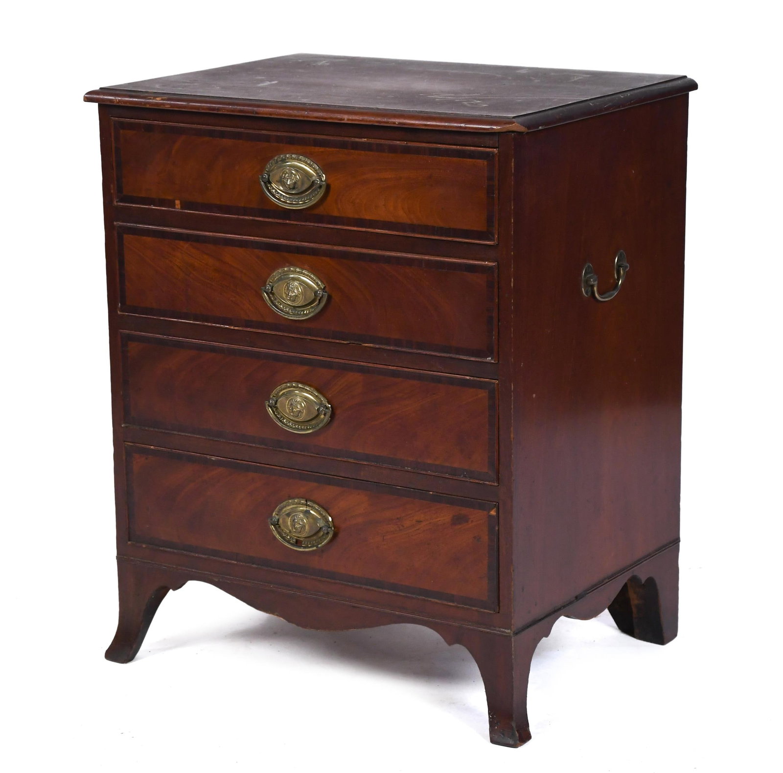 DIMINUTIVE 19TH C. AMERICAN FEDERAL MAHOGANY CHEST.: A ca. 1810 diminutive American Federal mahogany chest with four inlaid graduated drawers, set with original embossed lions heads brass hardware, on flared French feet. 28”H x 23.25”W x
