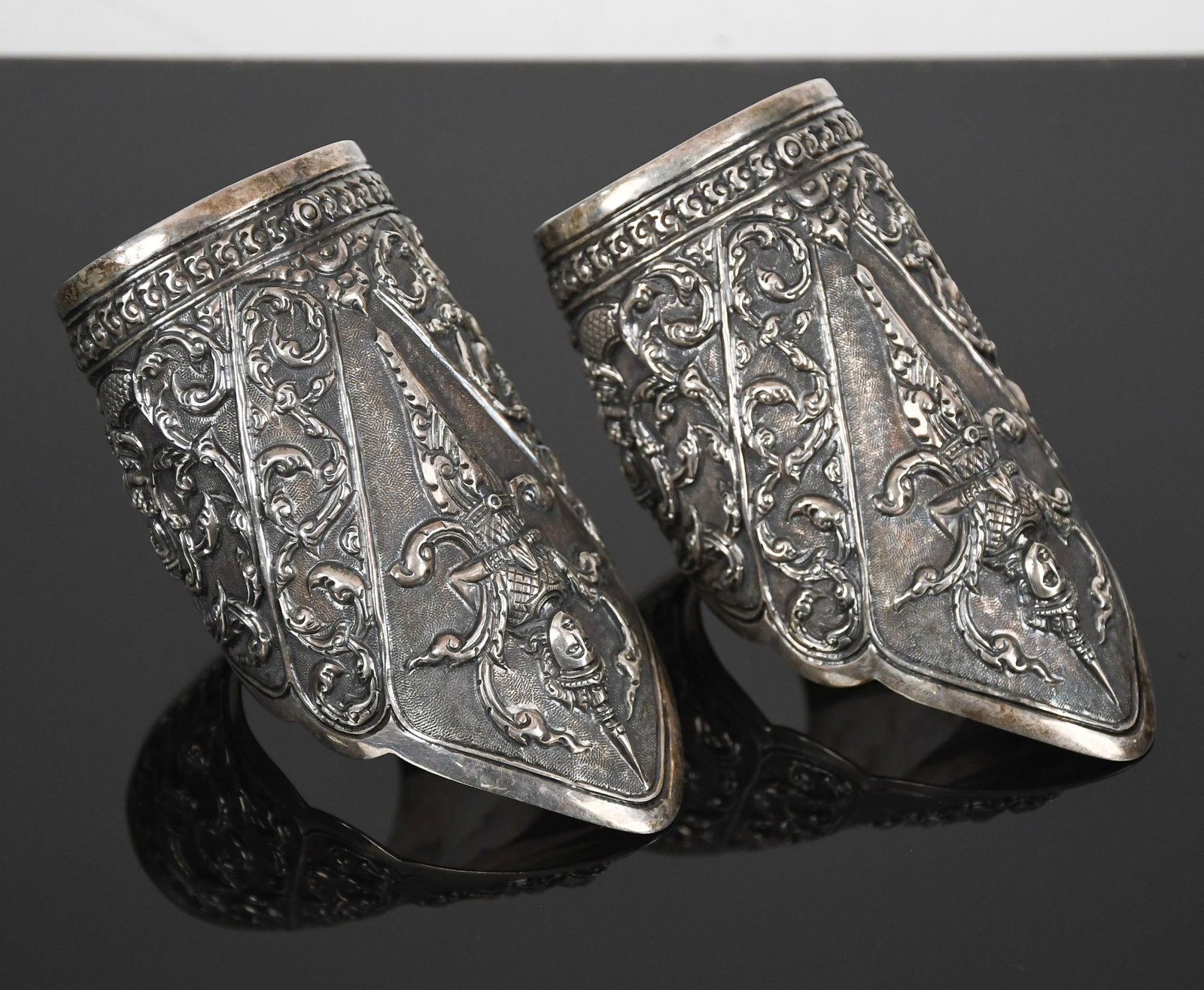PAIR OF VINTAGE STERLING SILVER THAI DEITY ARM CUFFS.: A pair of vintage, Thai deity, sterling silver (tested and stamped), arm cuffs, 5 inches long at center, 5 3/4 inch wrist, 1 inch opening, somewhat flexible, 8.25 oz t..