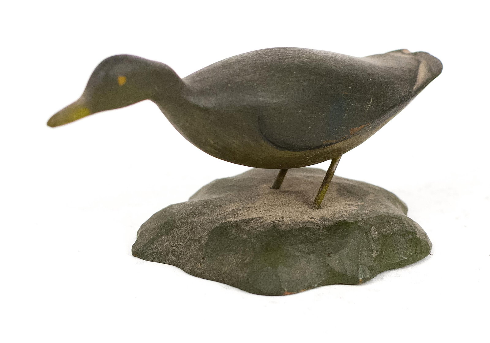 A. E. CROWELL MINI DUCK CARVING.: An early 20th century carved and painted miniature duck, paper label on bottom A. E. Crowell, 1.75“ x 3.5“.