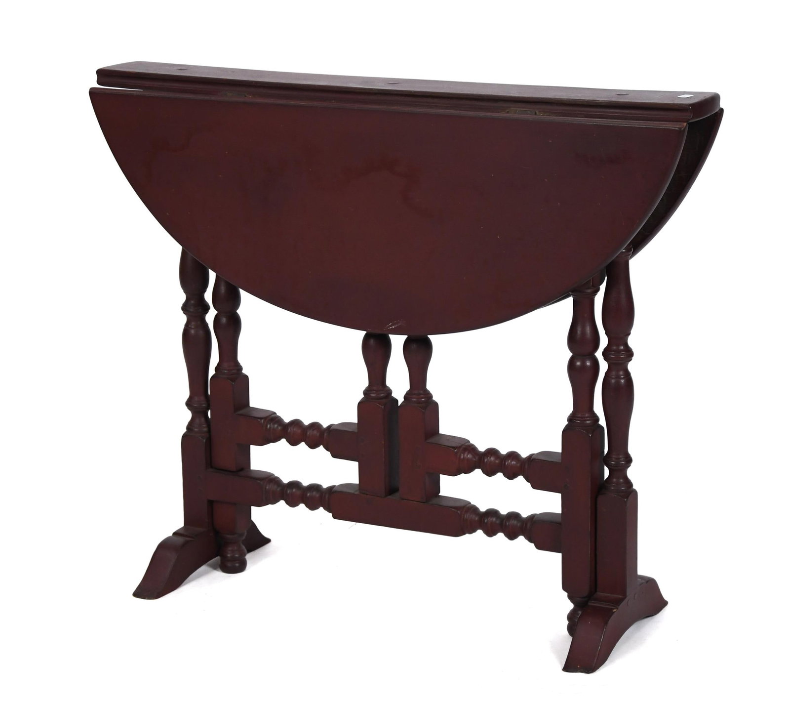 18TH C. NEW ENGLAND PAINTED TUCKAWAY TABLE.: An 18th C. New England red painted drop leaf tuck-away table with wonderful turnings, on shoe feet, 25.75”H x 31”L x 5” deep leaves down, 24.75” leaves up.