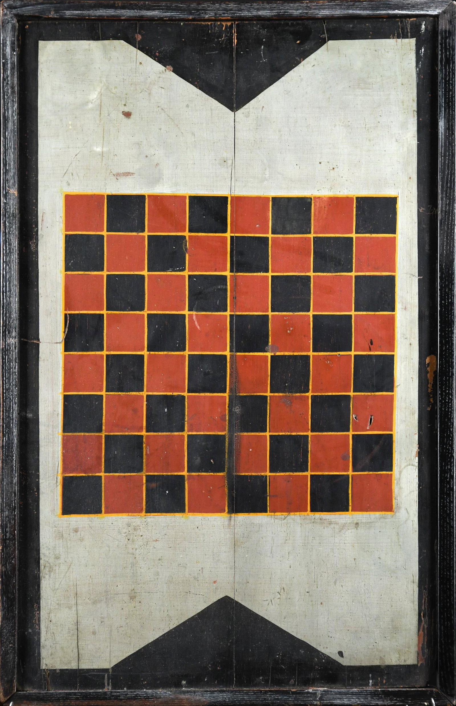 ANTIQUE POLYCHROME PAINTED CHECKERBOARD.: A late 19th century, polychrome painted checkerboard in red, black, yellow and gray paint with an applied molded edge, 31.5“ x 19.5“.