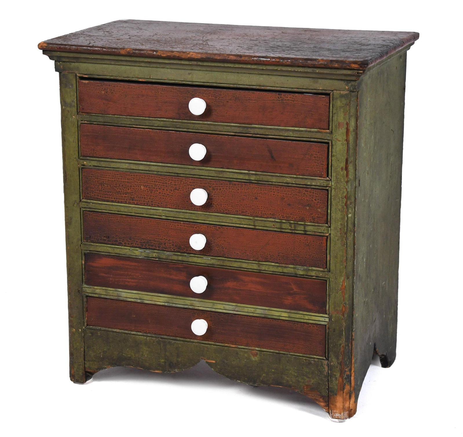 DIMINUTIVE 19TH C. PAINTED SIX DRAWER CHEST.: A good small size six drawer table top chest or map case with original red and green paint decoration, each drawer set with a white porcelain knob, on a cut out base. 27”H x 25”W x