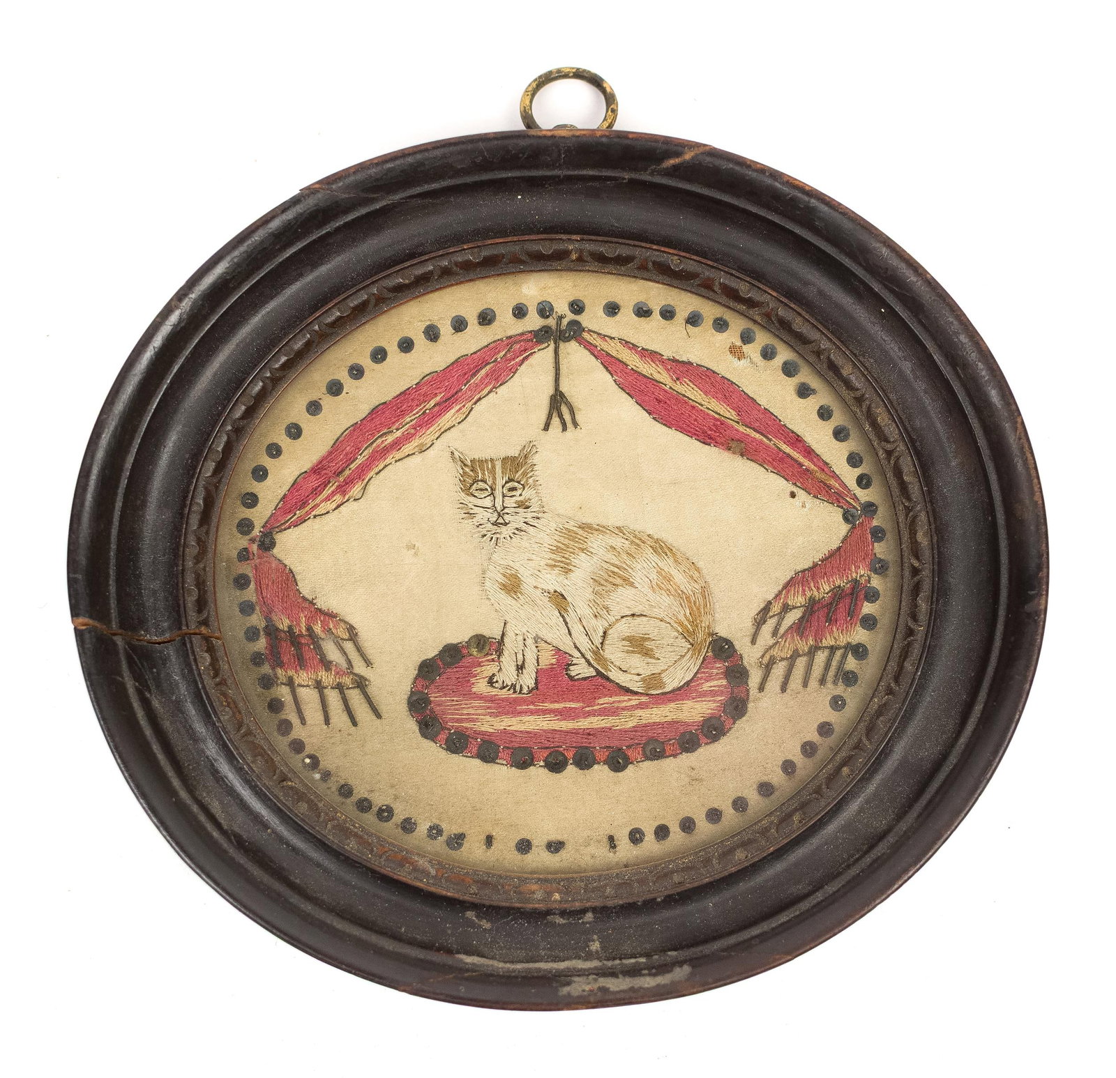 19TH C. DIMINUTIVE EMBROIDERY, CAT ON PILLOW.: A ca. 1820 miniature silk embroidery on silk ground with a charming depiction of a cat seated on rug/pillow, surrounded by Classical drapery and bulleted border. Image 3.5” x 4”, Frame
