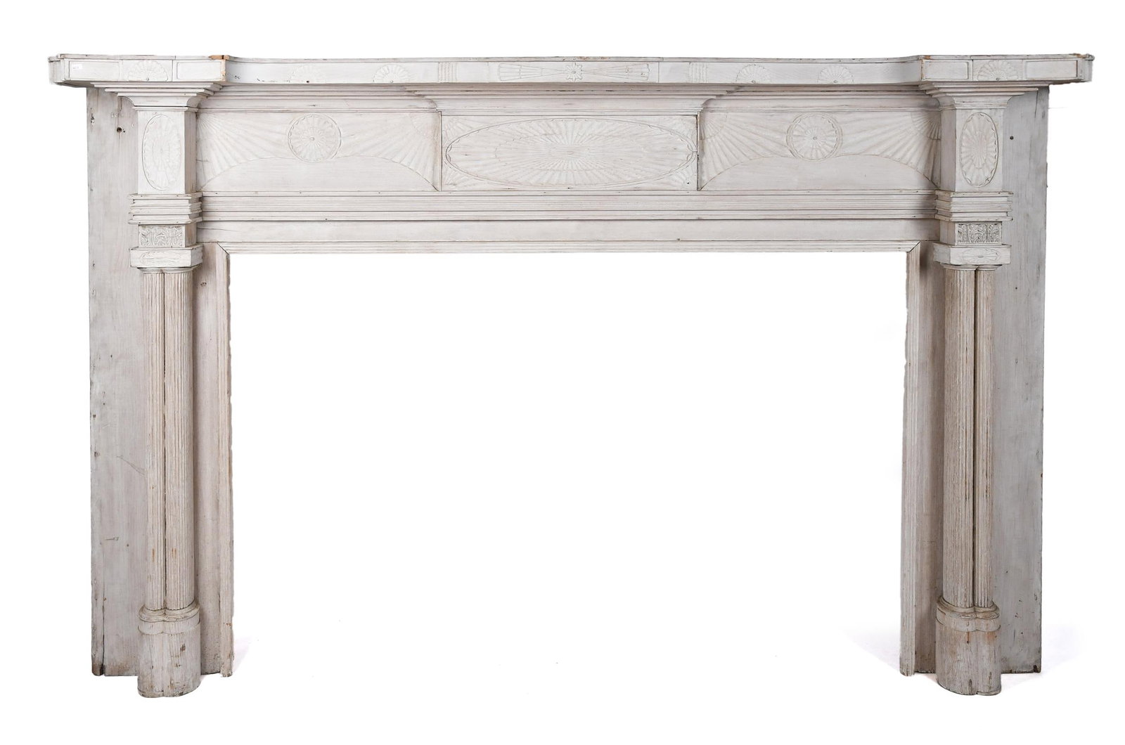 19TH C. AMERICAN FEDERAL CARVED FIREPLACE MANTEL.: A ca. 1820 American Federal gouge-carved mantel comprising of a carved stepped shelf above a three panel frieze with central carved oval form paterae and corner fans, flanked by smaller roundpaterae