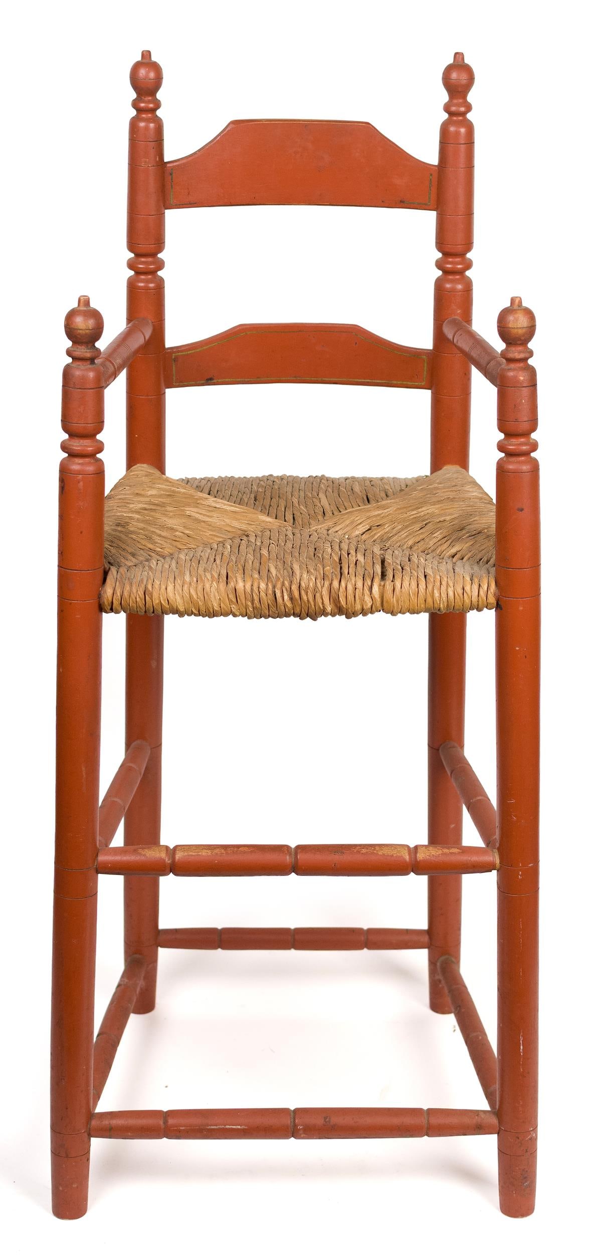 ANTIQUE RED PAINTED CHILDS HIGH CHAIR.: A 19th C. child’s highchair with fine turnings and old red paint. Turned finials and two ladder back with a rush seat. 36”H x 13”W x 21” seat H. Provenance: from the lifelong,