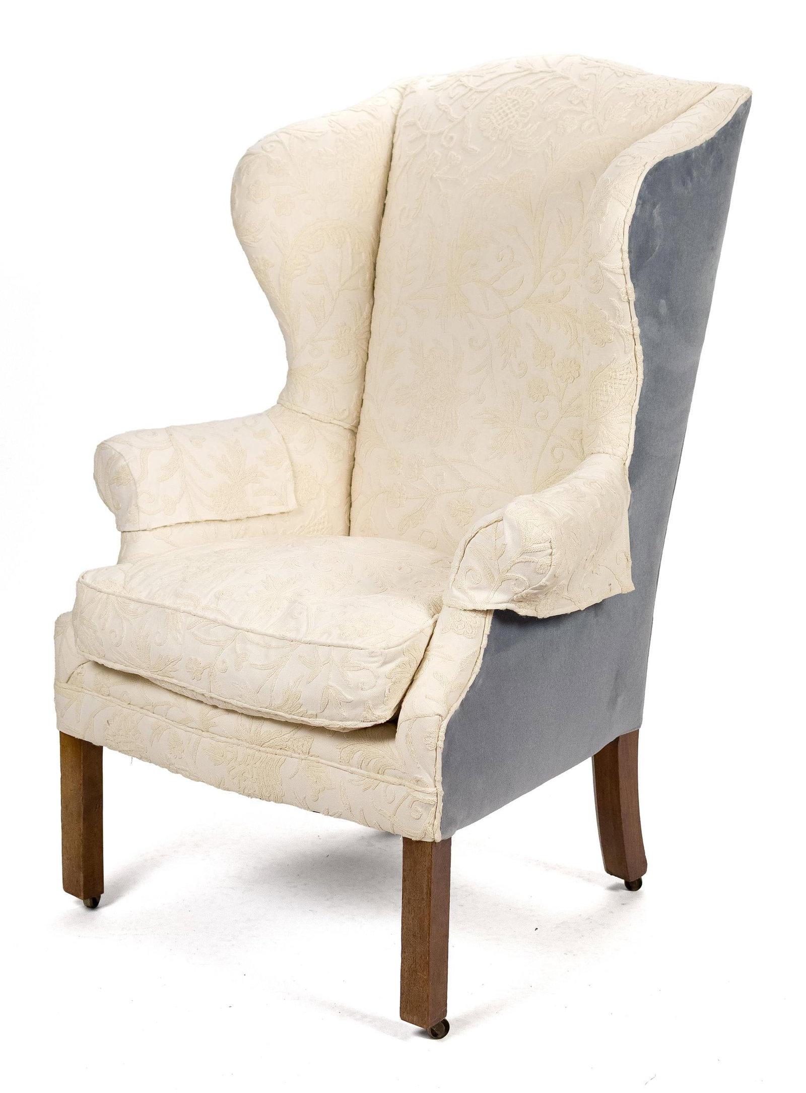 18TH C. CHIPPENDALE NEW ENGLAND WING CHAIR.: A ca. 1780 Chippendale New England birch wing chair, scrolled crest rail, shaped wings, rolled arms on straight square chamfered legs with recessed casters, upholstered in a off white floral crewel