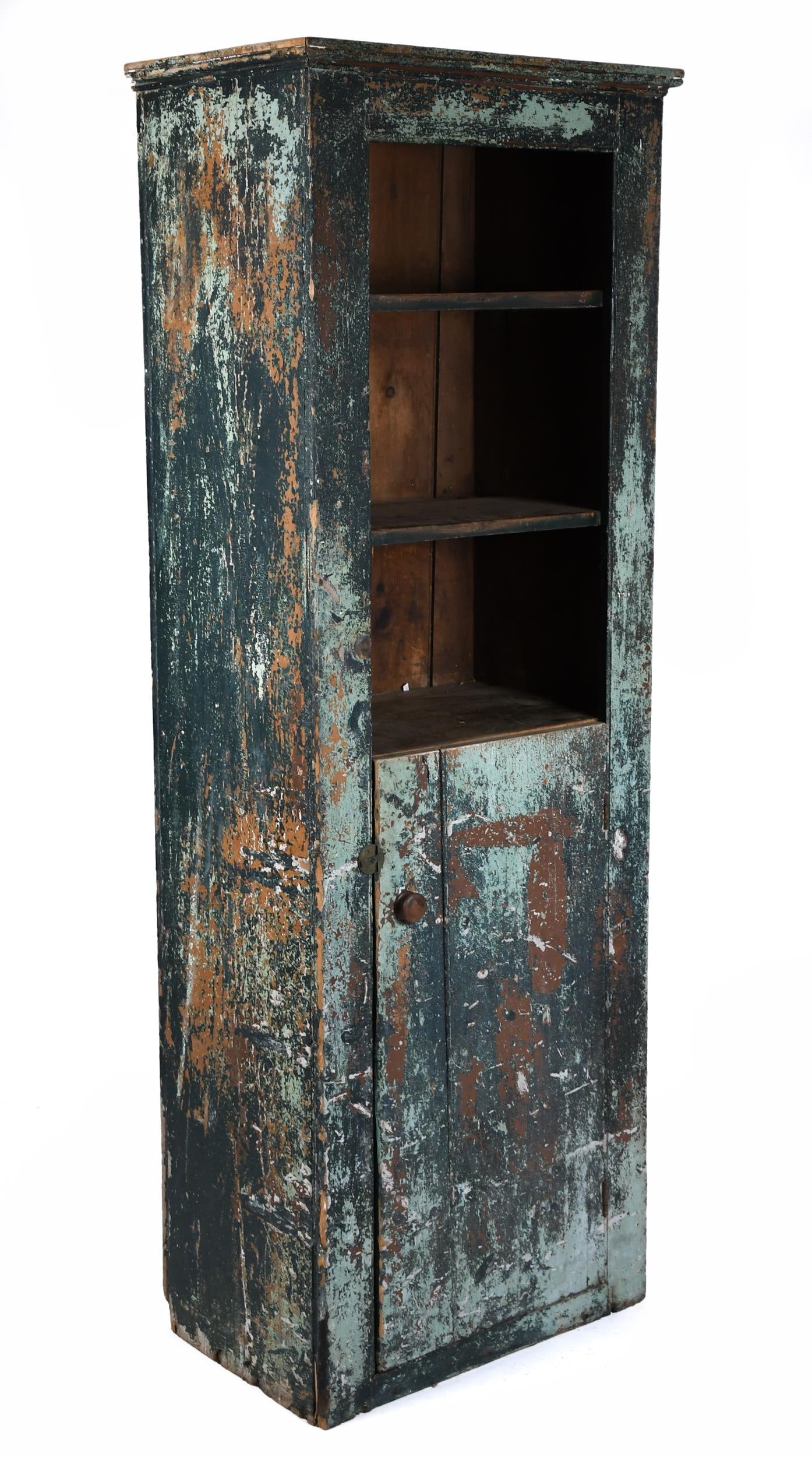 19TH C. AMERICAN CHIMNEY CUPBOARD IN OLD PAINT.: A 19th C. American country primitive chimney cupboard in old distressed green paint. An open top, the lower section with a blind paneled door. 79”H x 26”W x 17.25”D