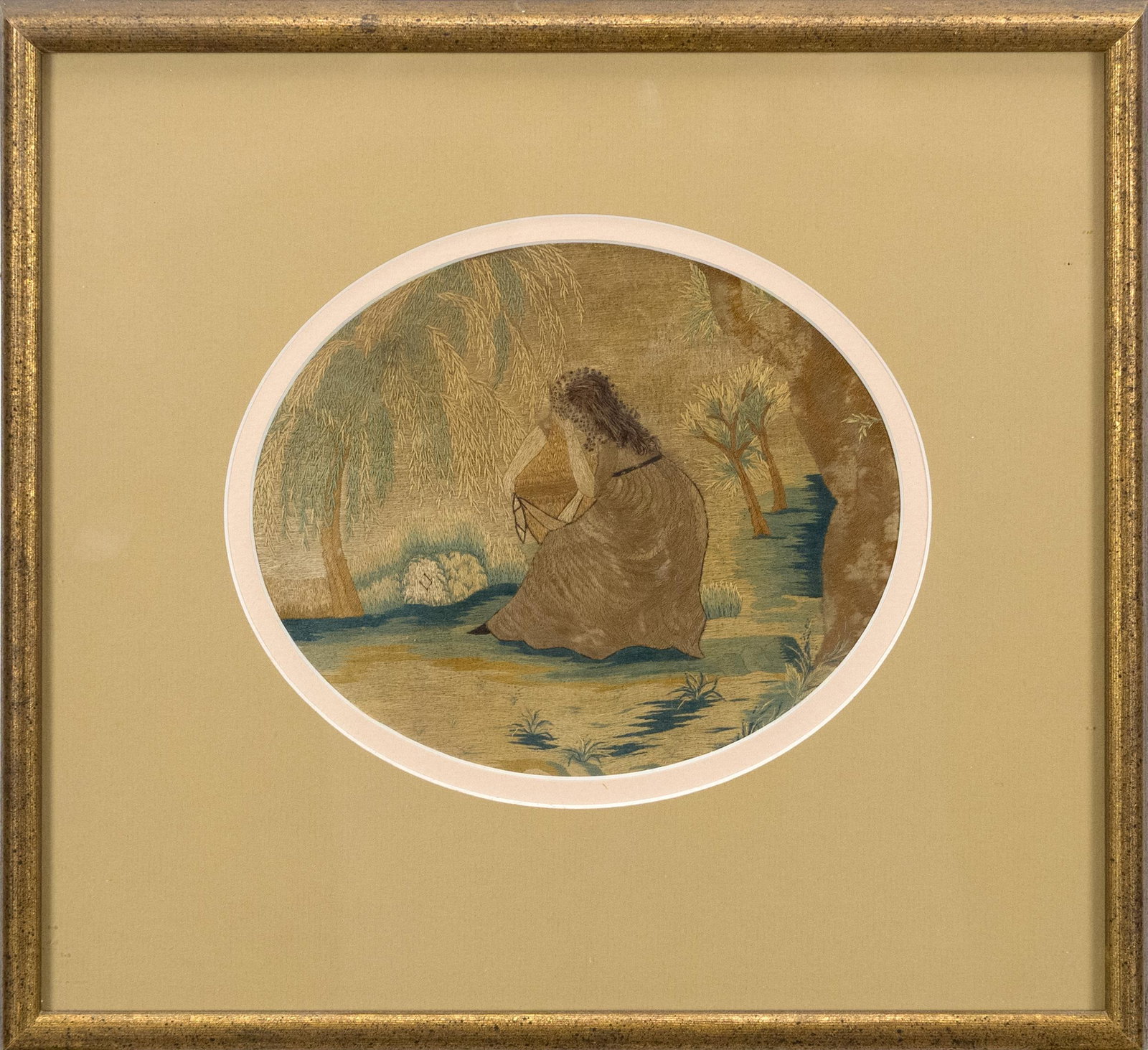 19TH C. EMBROIDERED SILK MOURNING SCENE.: 19th C. mourning scene in oval matting with woman under a Weeping Willow tree. Image 7” x 5.5”, Frame 12.25” x 11.25”.