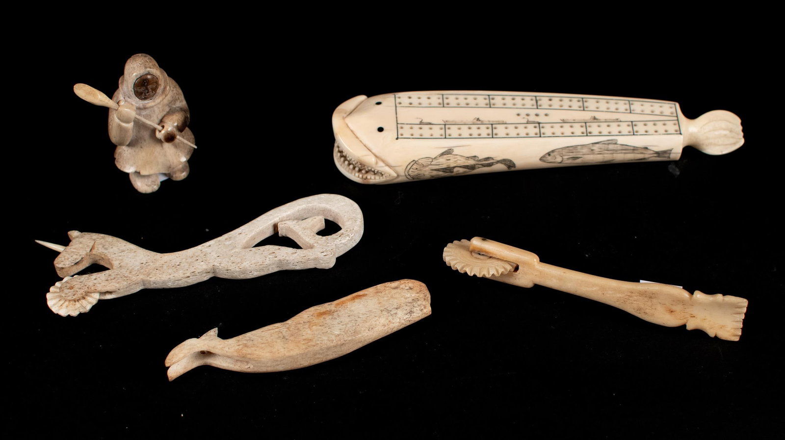 ANTIQUE SAILOR-CARVED WHALEBONE OBJECTS, 5PCS.: Five antique pieces of sailor-carved whalebone, including: cribbage board with scrimshaw decorations 8.5”L, unicorn pie crimper 6.5”L, other pie crimper 7.5”L and others. Provenance: