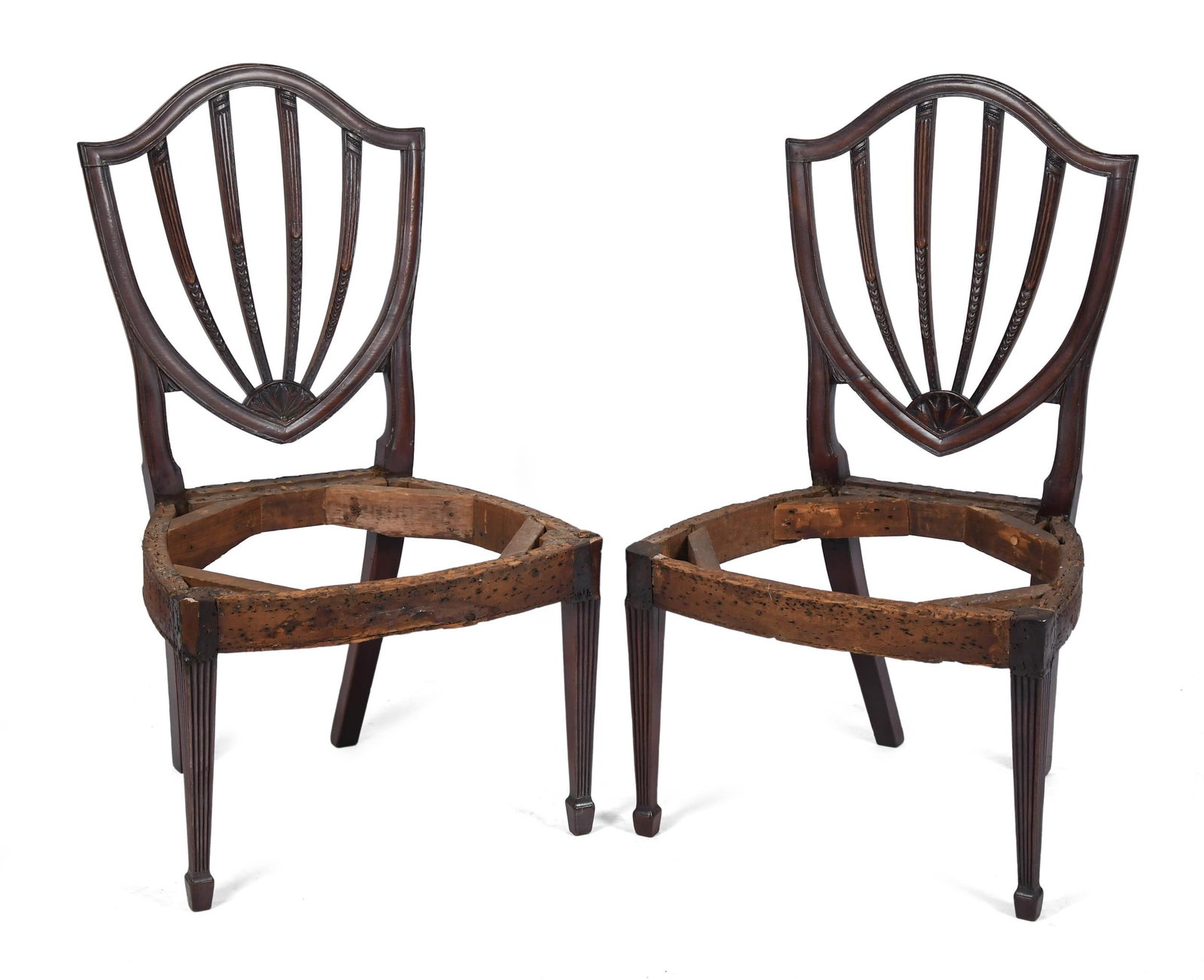 PAIR 19TH C. AMERICAN FEDERAL SIDE CHAIRS.: A pair of ca 1800 American carved mahogany shield back side chairs with exposed seat frames (no upholstery) on tapered reeded legs. 38”H x 22.25”W x 21.5”D x 16”Seat.