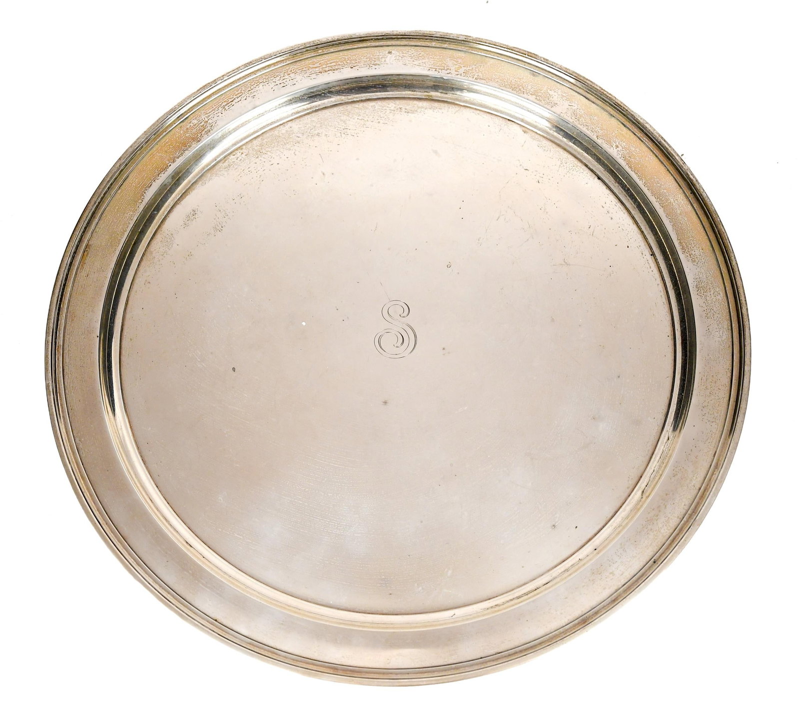 LARGE VINTAGE TIFFANY STERLING CHARGER.: A large ca. 1940 Tiffany sterling charger with shallow basin and raised rim, monogrammed ‘S’, and marked on the bottom, Tiffany & Co Makers Sterling Silver 20221. 36.75 oz t. 15”