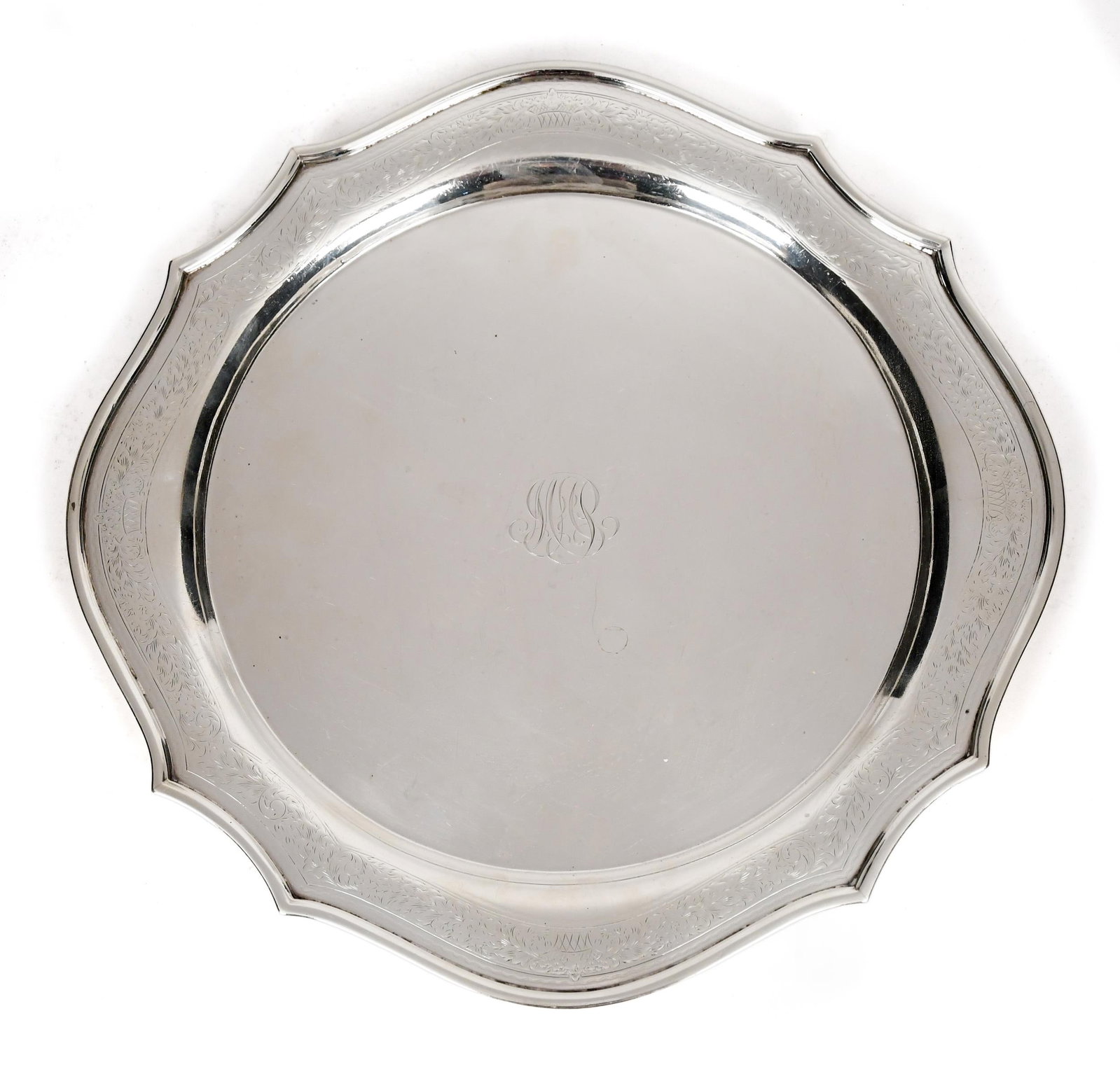 KENSINGTON INTERNATIONAL STERLING CHARGER.: A vintage Kensington International sterling 810-30A monogrammed charger with scalloped edge and delicate engraved detailing. 27.65 oz t. 12.5” dia.