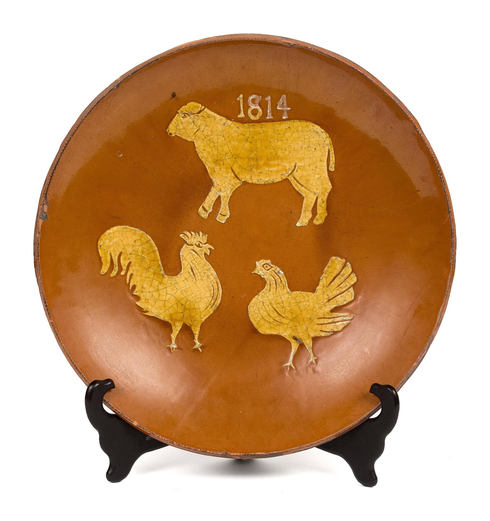 GREG SHOONER SLIP DECORATED REDWARE PLATE.: A 20th C. redware plate, slip decorated with a cow and rooster dated 1814, reverse reads ‘original possibly by Bixler Pennsylvania 1814 museum peace 1990 Greg Shooner’, 14.5” dia.