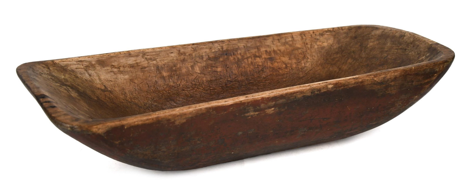 ANTIQUE WOODEN TRENCHER IN RED PAINT.: An early 19th C. carved wooden rectangular trencher in an old red paint, 6”H x 28”W x 11.5”W.