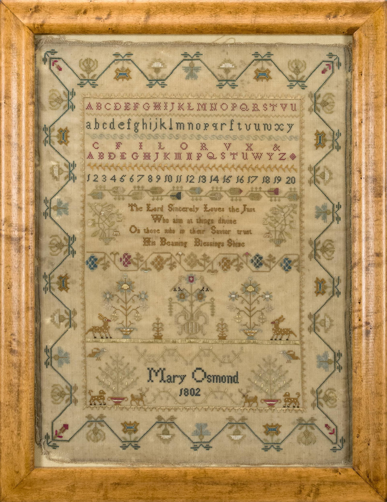 1802 MARY OSMOND SAMPLER.: An early 19th C. needlework sampler with floral motif border and alphabet and verse in center. Verse, ‘The Lord Sincerely Loves the Just Who aim at things divine On those who in their Savior