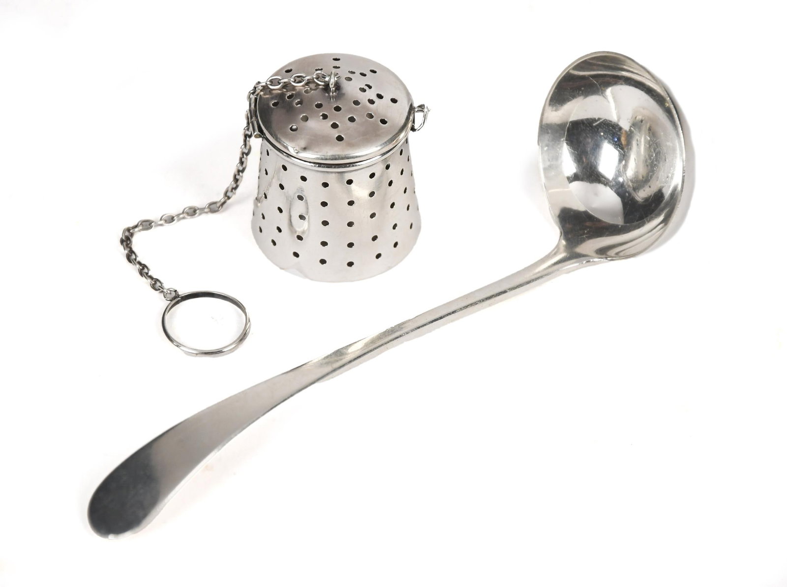 VINTAGE STERLING TEA STRAINER AND TODDY LADLE.: Two vintage sterling items including, a Tiffany & Co. sterling toddy ladle original reproduction of an 1806 Edinborough, Scotland design, 1.10 oz t. 5.5”L. Along with a sterling tea strainer