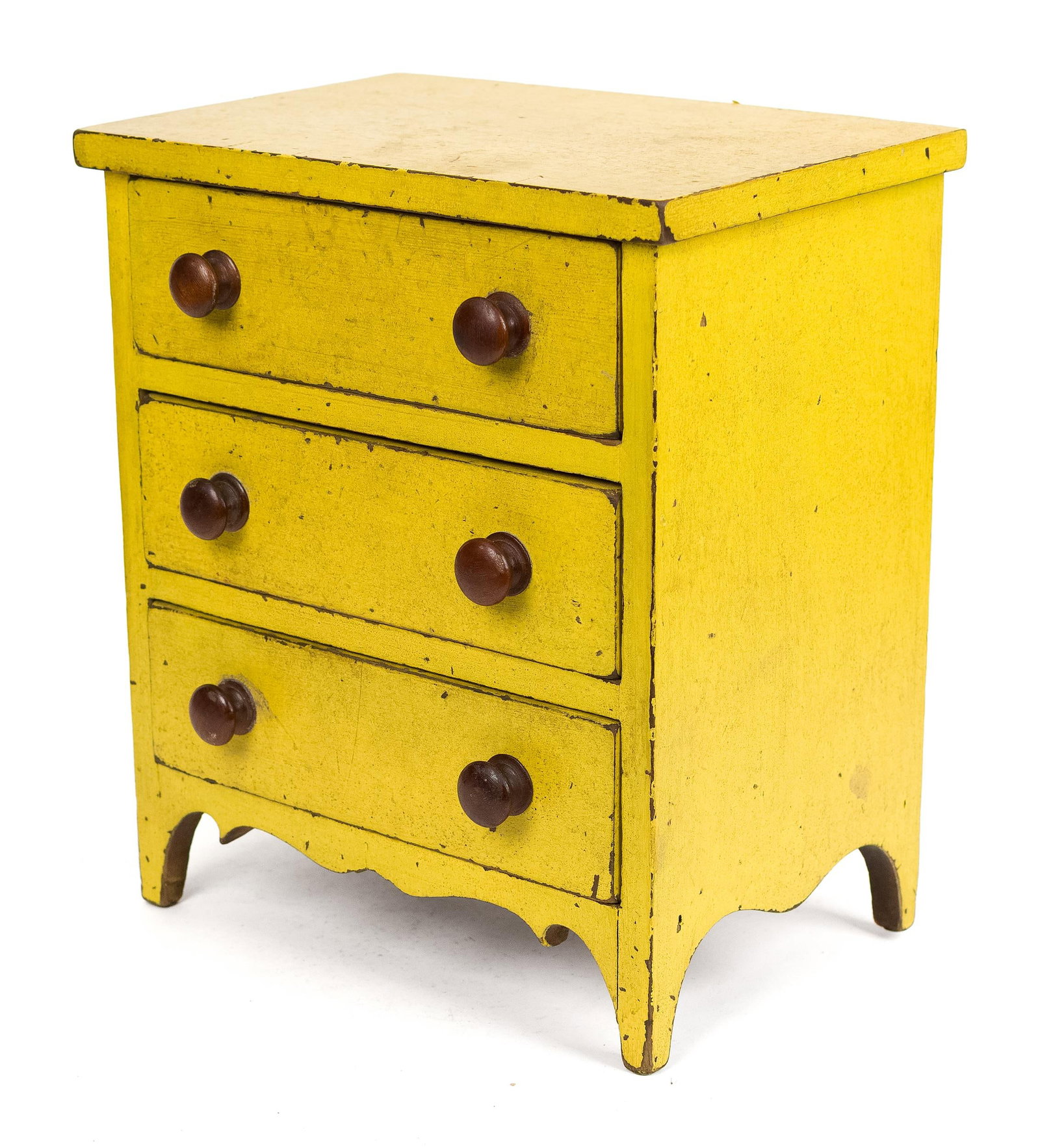 19TH C. FEDERAL YELLOW PAINTED MINIATURE CHEST.: An early 19th C. Hepplewhite yellow painted pine chest with three dovetail drawers on a nice scroll apron on cut out feet, 13.25”H x 11.5”W x 8”D