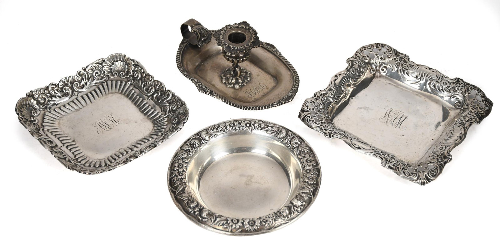 STERLING CHAMBER STICK & THREE SMALL PLATES.: A sterling chamber stick with gadrooned edges and floral acanthus decoration, 2.25”H, along with three sterling repousse plates. 14.45 oz t.