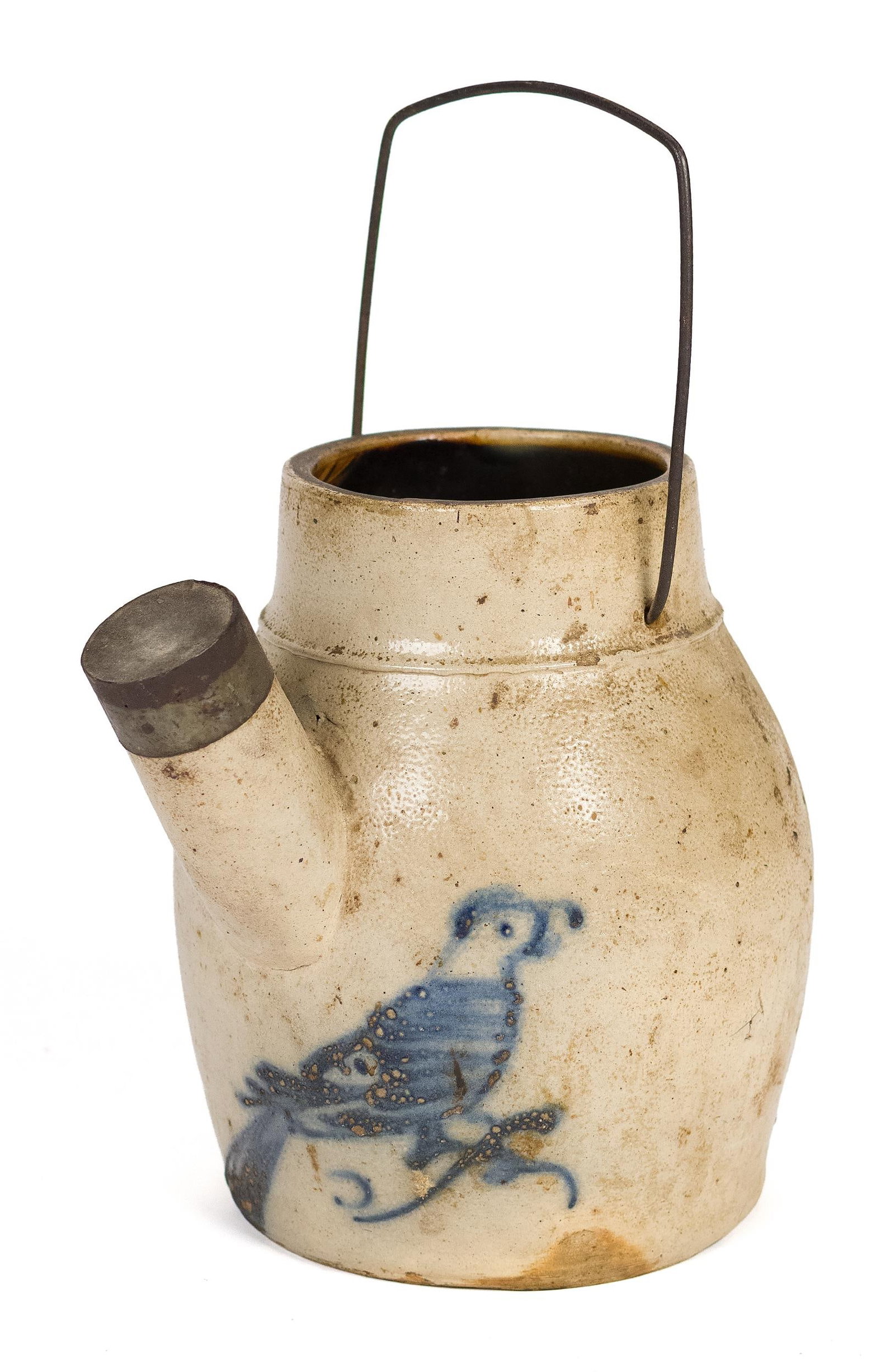 19TH C. STONEWARE BATTER PITCHER, BIRD DESIGN.: A 19th century stoneware batter, pitcher with wire handle and spelt with tin cap decorated with a cobalt blue bird, 9”H