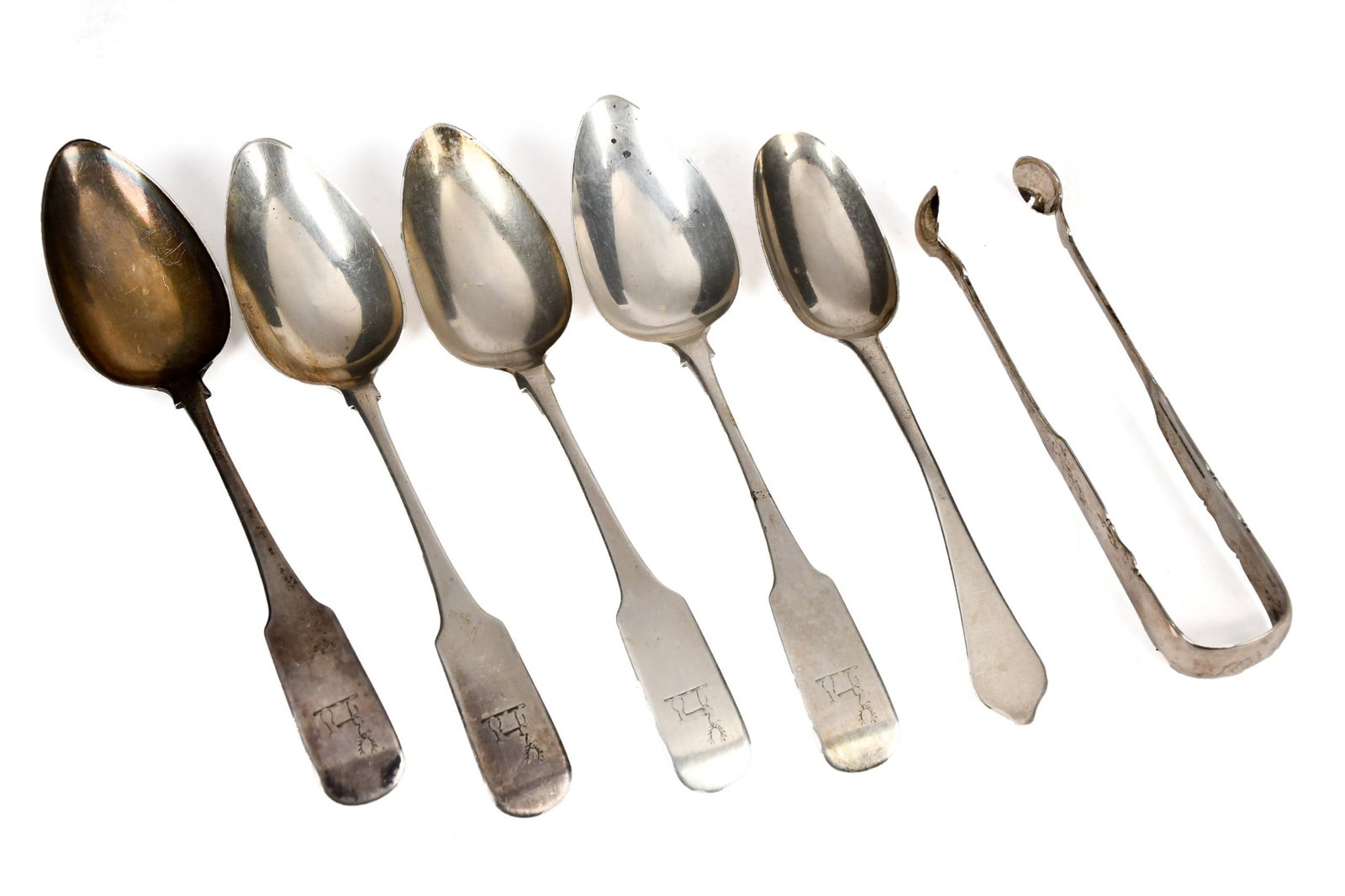 SIX ANTIQUE IRISH AND OTHER SILVER FLATWARE.: Six antique sterling spoons and one pair of sterling sugar tongs.12.30 oz t. Spoons 9”L, Tongs 6.75”L.