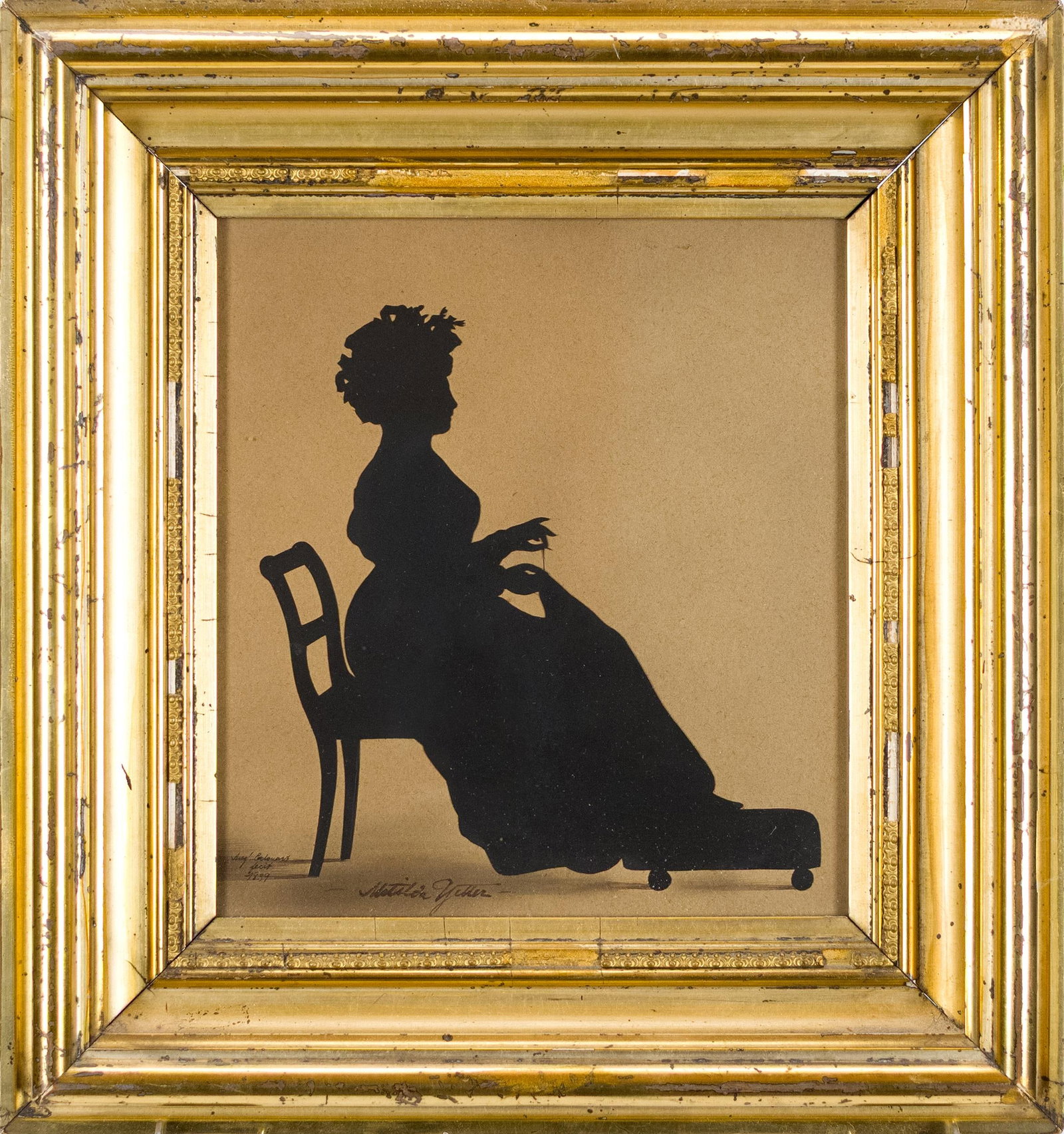 1839 AUGUSTE EDOUART SILHOUETTE, WOMAN SEWING: A dated 1839 signed Auguste Edouart (1789-1861) silhouette of a young woman (identified in artist’s hand as ‘Matilda Yetter’), seated in a chair sewing with feet on an ottoman.