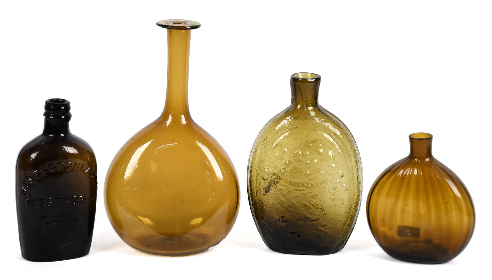 FOUR ANTIQUE BLOWN BOTTLES/FLASKS.: An antique Westford Glass Co. Westford Conn bottle, 6”H, an antique Cornucopia/Eagle flask 7”H and two other bottles, 5” & 9”H.