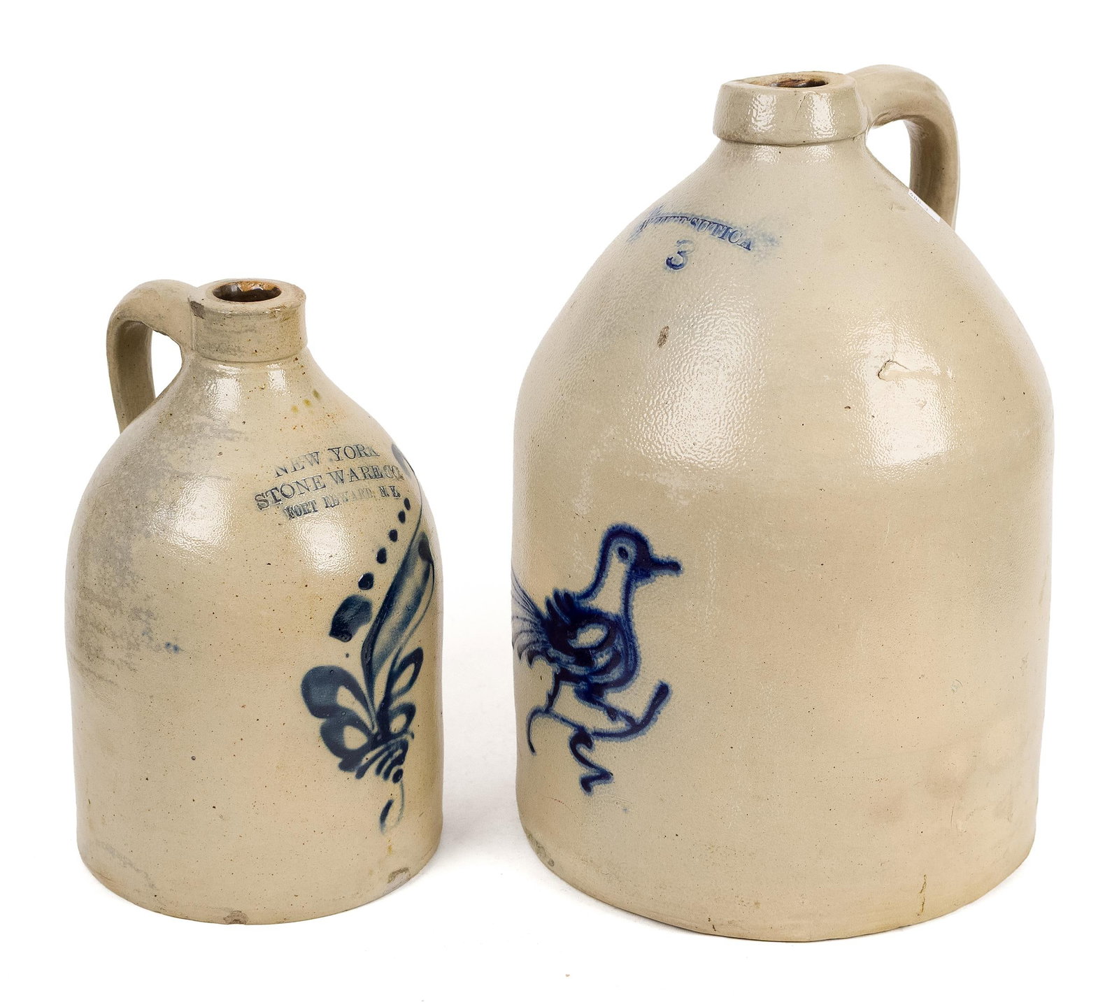 TWO 19TH C. DECORATED STONEWARE JUGS.: A three-gallon antique White’s Utica stoneware jug with cobalt chicken decoration 15”H, along with a New York Stoneware Co, Fort Edward NY jug having a cobalt floral
