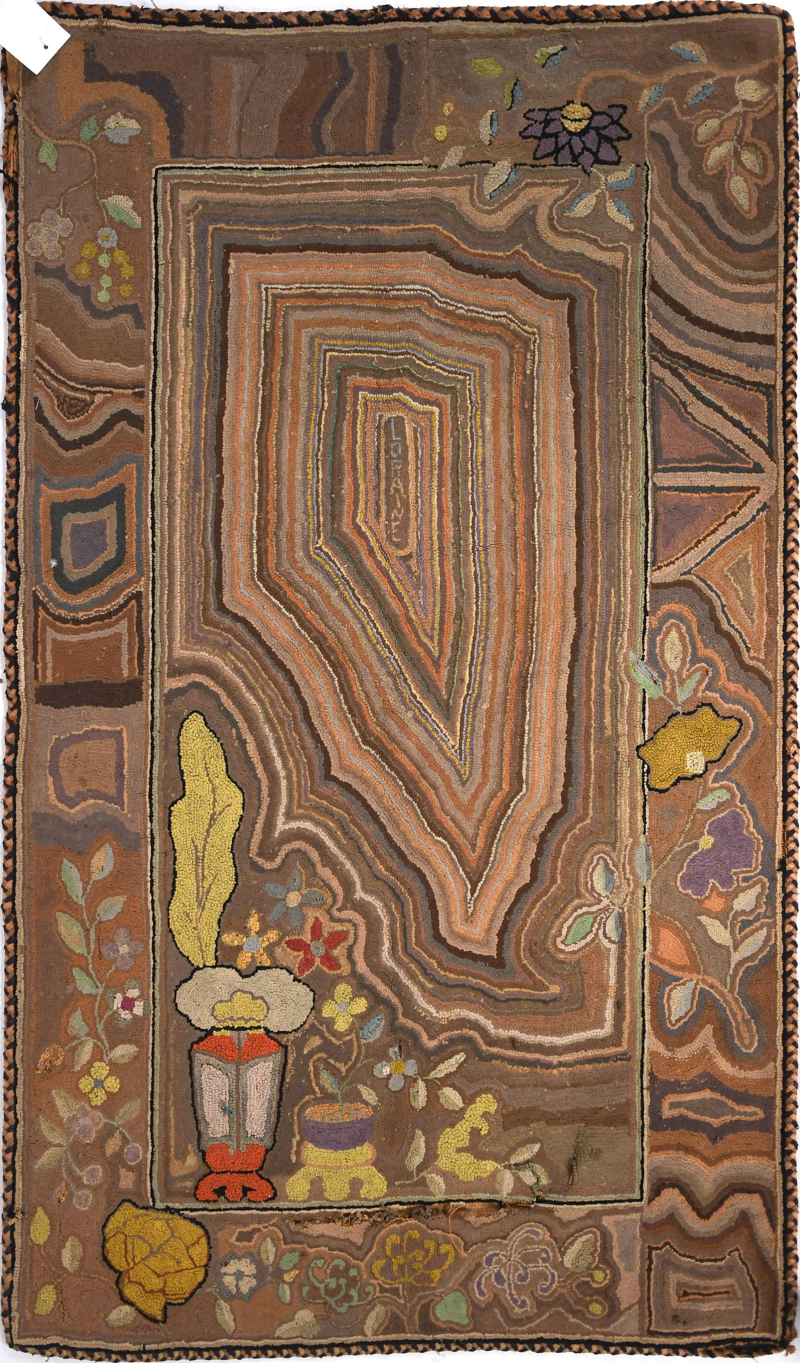 UNUSUAL ANTIQUE HOOKED RUG, LORRAINE.: An antique small hooked rug with unusual geometric design with vase of flowers and lettering, Lorraine.3’ x 4’11”.