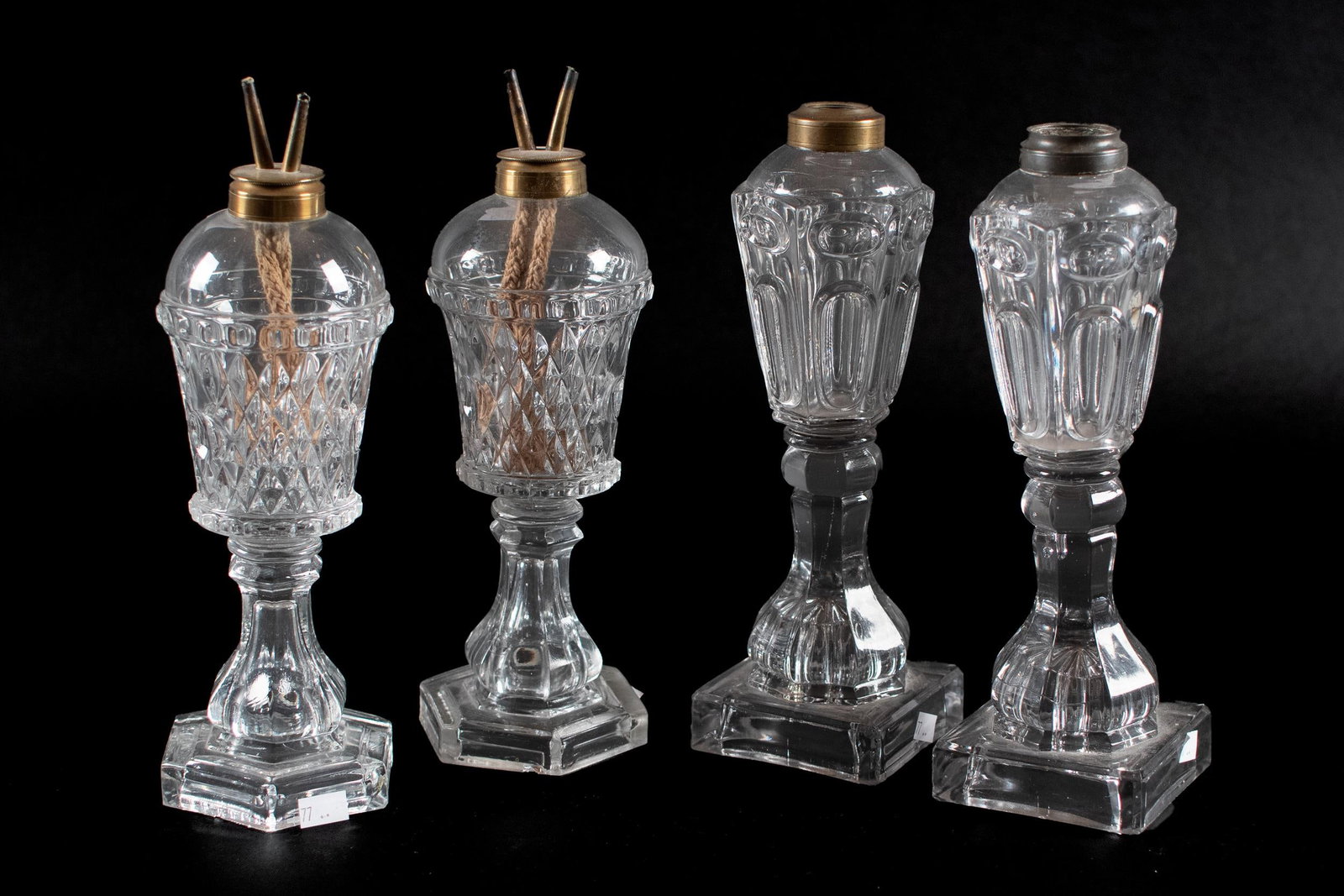 TWO PAIR OF 19TH C. GLASS WHALE OIL LAMPS.: Two pair of 19th C. glass whale oil lamps. One pair (likely Boston & Sandwich) pressed glass with diamond pattern and metal collars, stems and wicks on hexagonal base. The other molded glass with