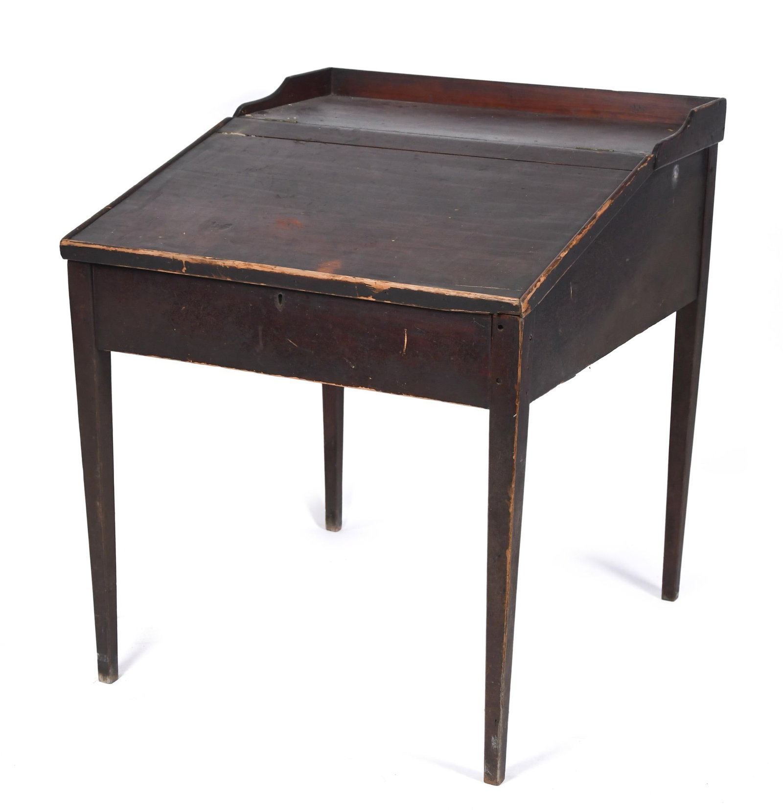 ANTIQUE COUNTRY DESK ON HIGH LEGS.: A 19th C. American country dark red stained pine slant top clerks desk on high tapered legs. 35”H x 30.75”W x 34”D.