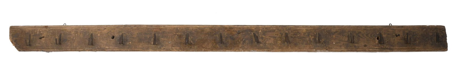 ANTIQUE WOODEN HOOK HANGER.: A 19th C. long wooden hook hanger with 14 hooks and chamfered top and bottom edges. 78.5”L. Provenance: from the lifelong, curated collection of Kathy Schoemer, Walpole, NH.
