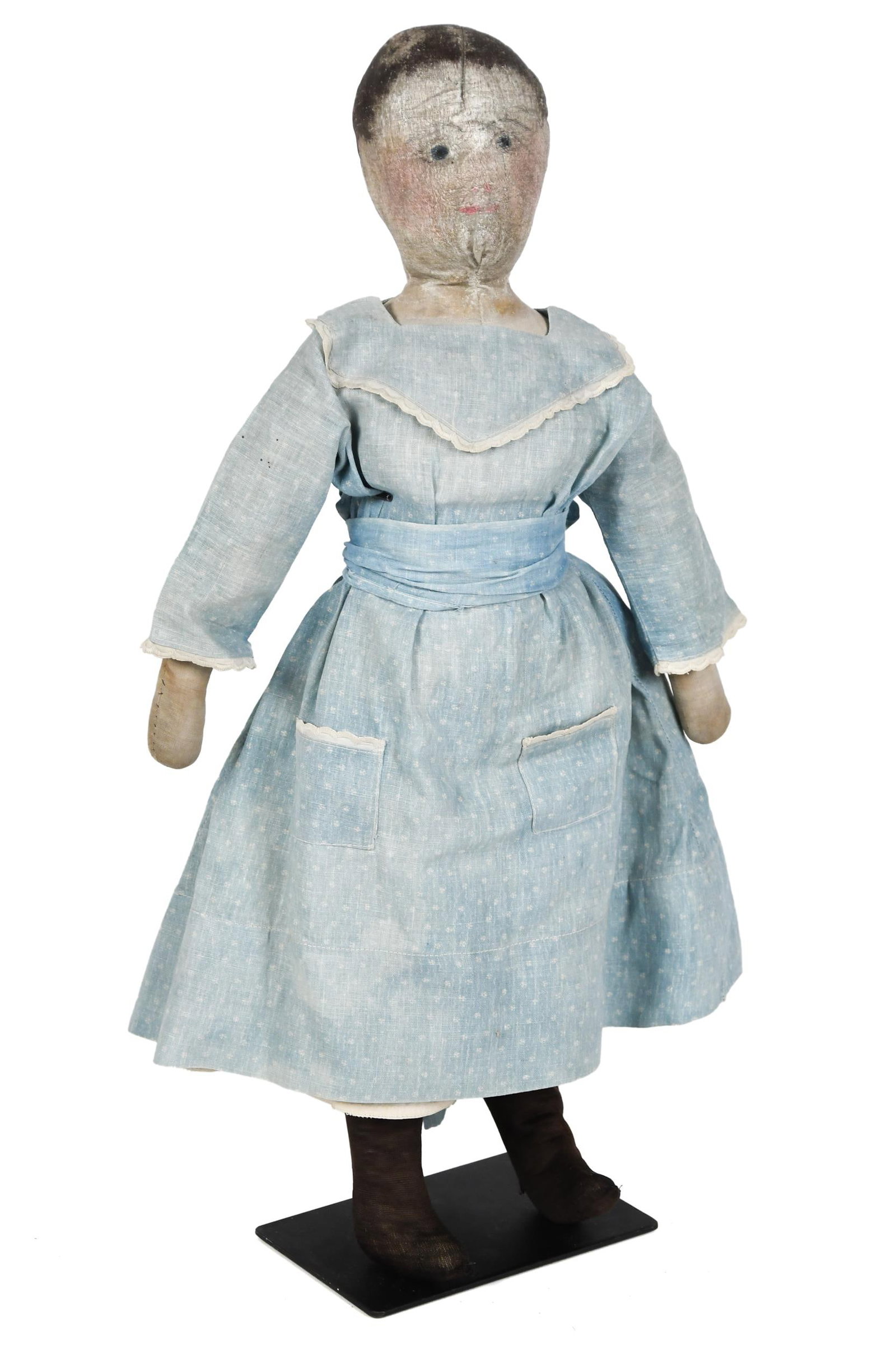 ANTIQUE CLOTH PAINTED FACE DOLL.: A ca. 1900 cloth doll in original blue dress with painted face. Once part of the Eleanor V. Lakin Collection and featured on page 132 of Lakin’s ‘Folk Art for Children.’ 21”H.