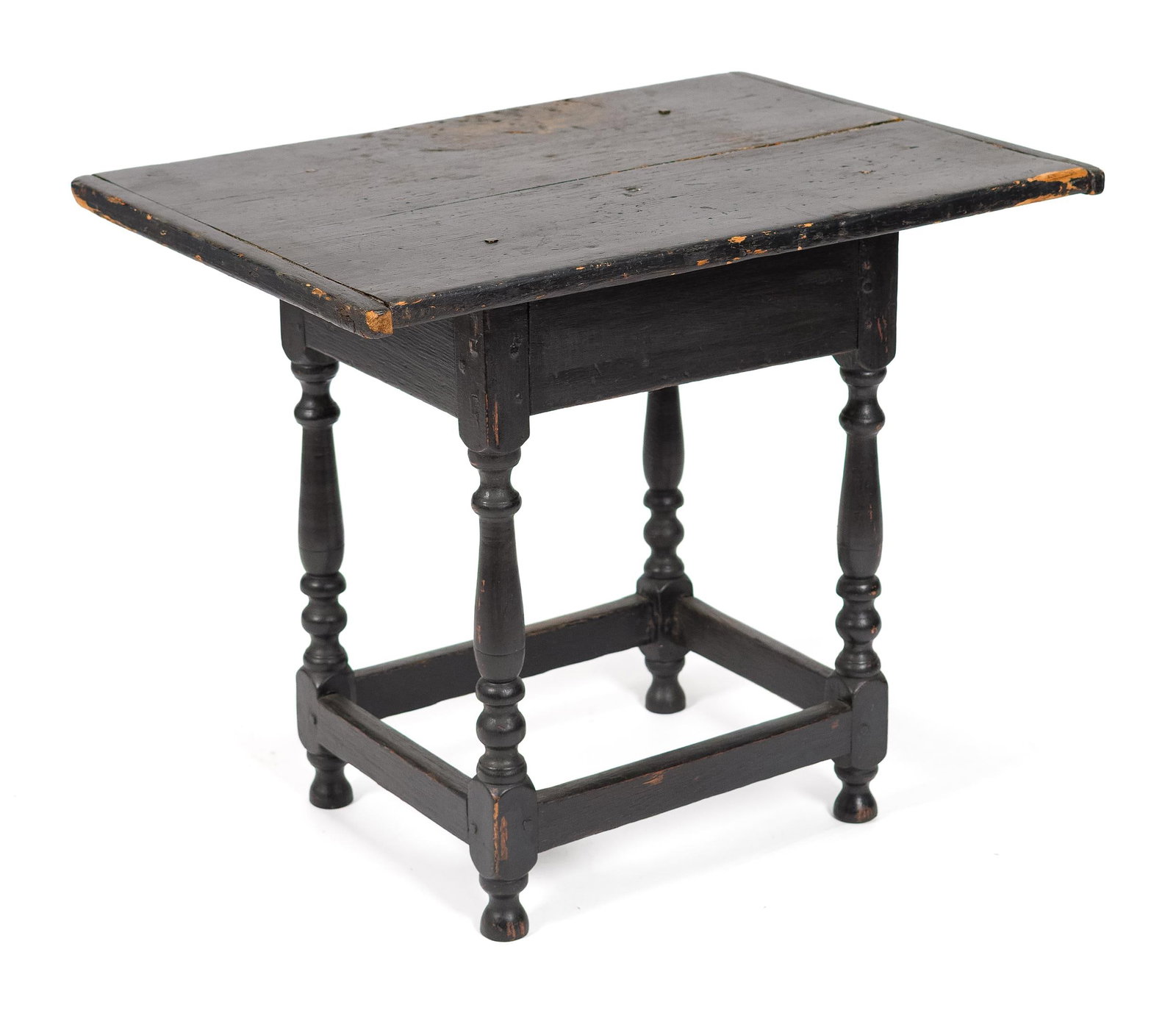 EARLY 18TH C. WILLIAM AND MARY TAVERN TABLE.: A ca. 1730 William and Mary country tavern table, in an old black paint. The original breadboard end top with molded edge overhanging a plain skirt, raised on baluster turned legs joined by a box