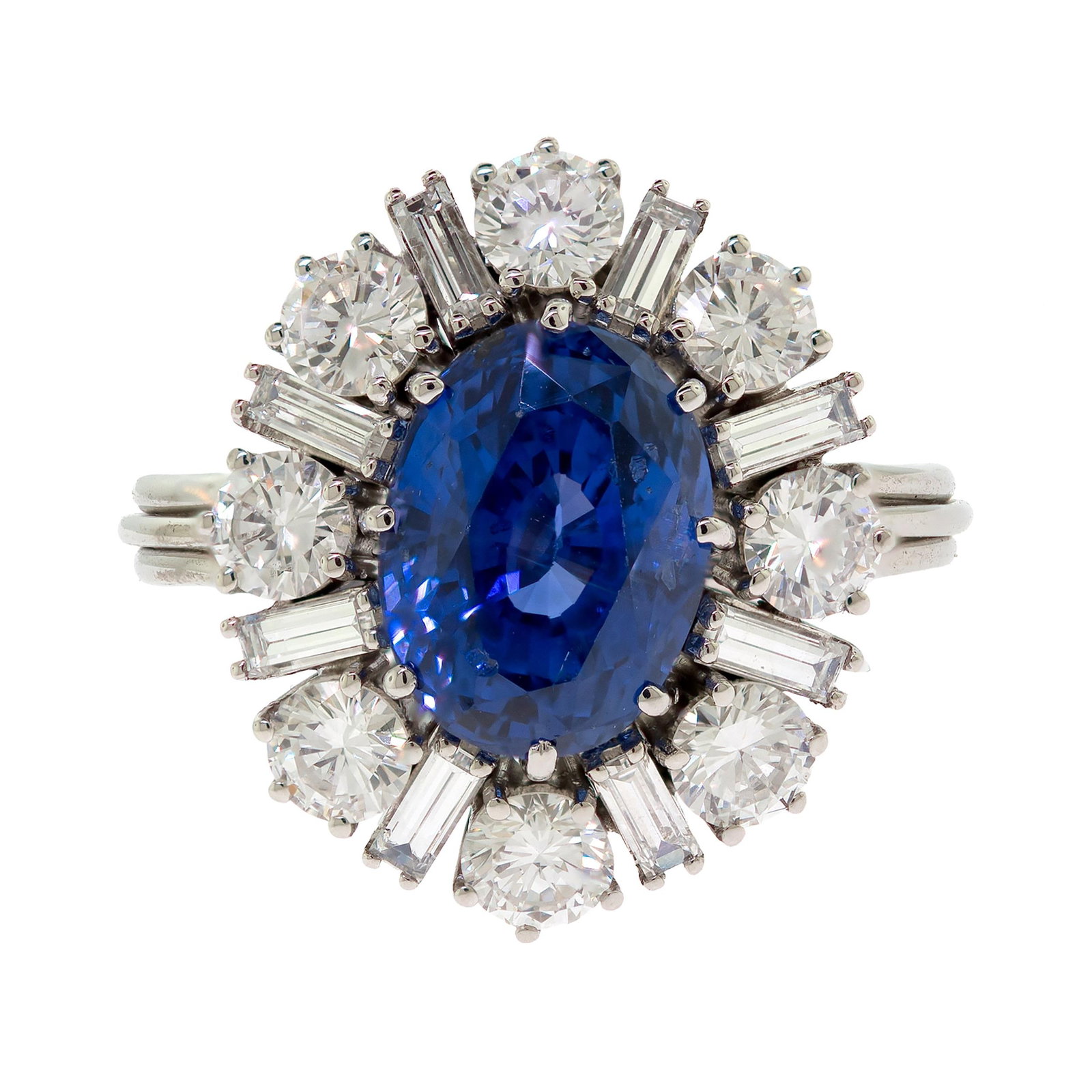 PLATINUM 5.5 CT. NO HEAT SAPPHIRE & DIAMOND RING.: A platinum (tested) halo-style ring set with an approx. 5.5 ct., faceted oval, medium, slightly violetish-blue sapphire, measuring, 10.95 x 8.27 x 7.71mm deep, accompanied by a GIA Report