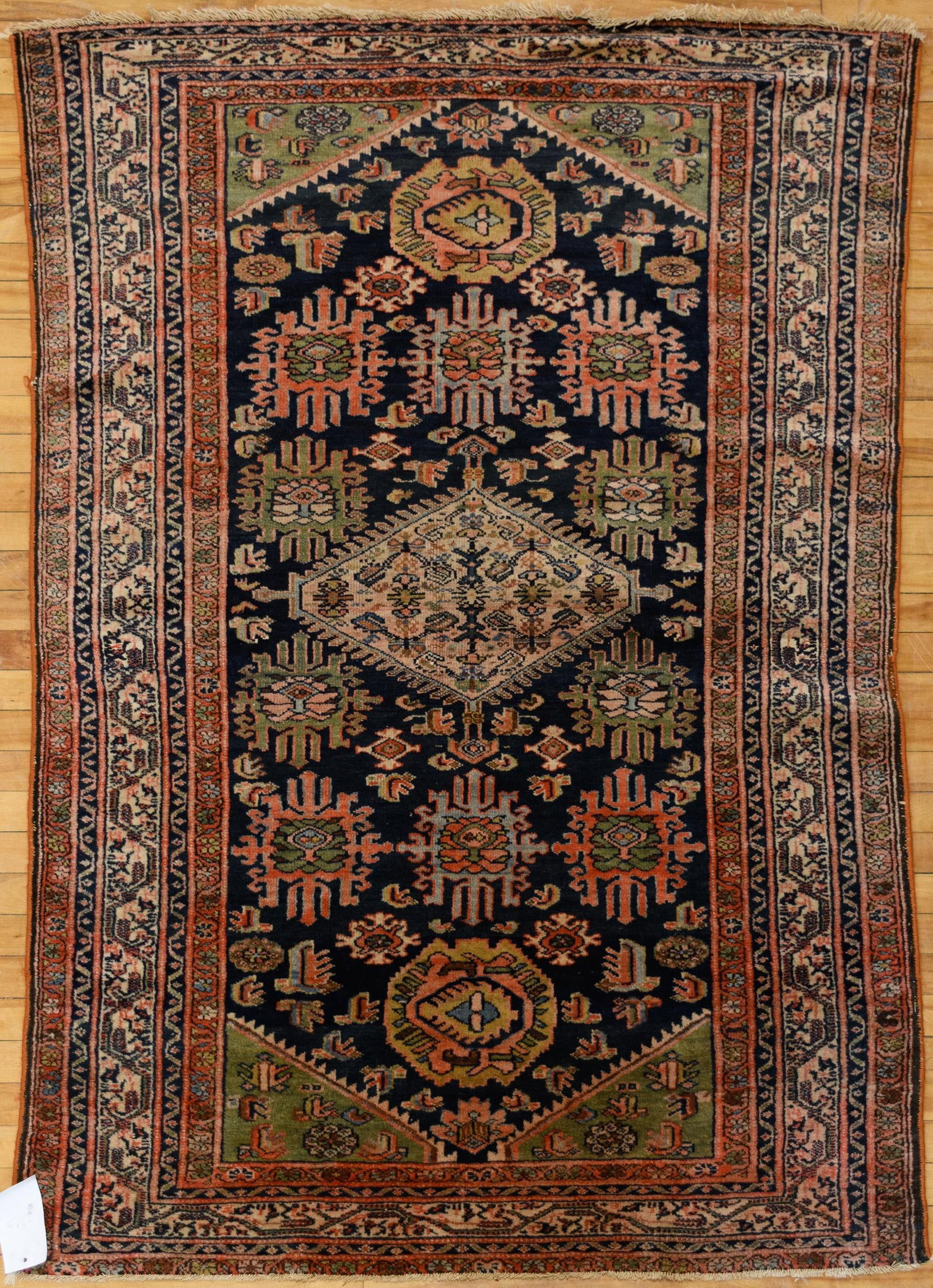 ANTIQUE PERSIAN BLUE GROUND ORIENTAL SCATTER RUG.: An antique Persian oriental scatter rug, the midnight blue field with an allover geometric floral design centered by an ivory lozenge medallion, with polychrome anchor palmettes above and below and gr