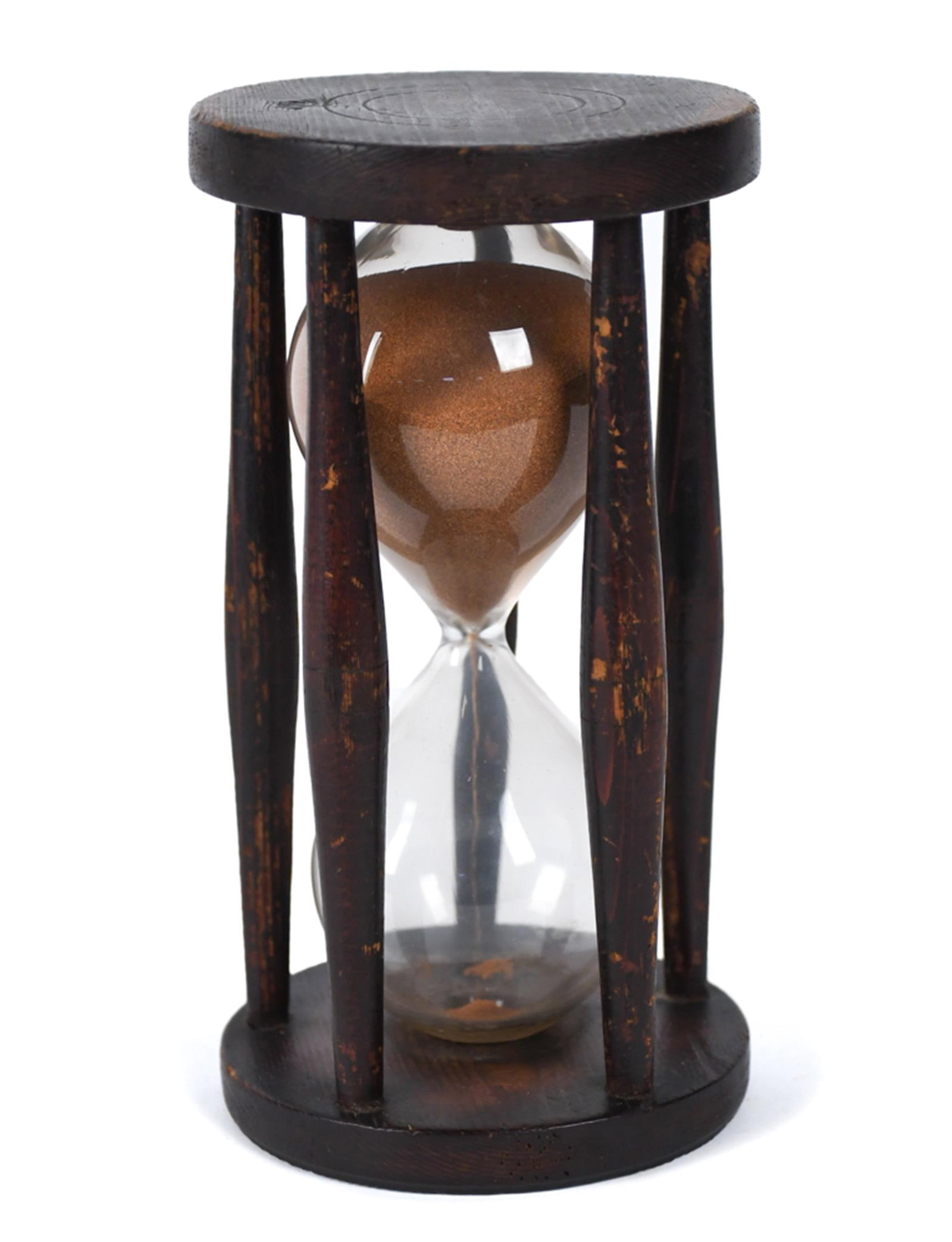 EARLY AMERICAN PINE HOURGLASS.: A ca. 1800 pine hourglass, the clear blown glass ampoule filled with fine sand, held between turned circular top and base plates joined by four shaped baluster columns, retaining its original finish.