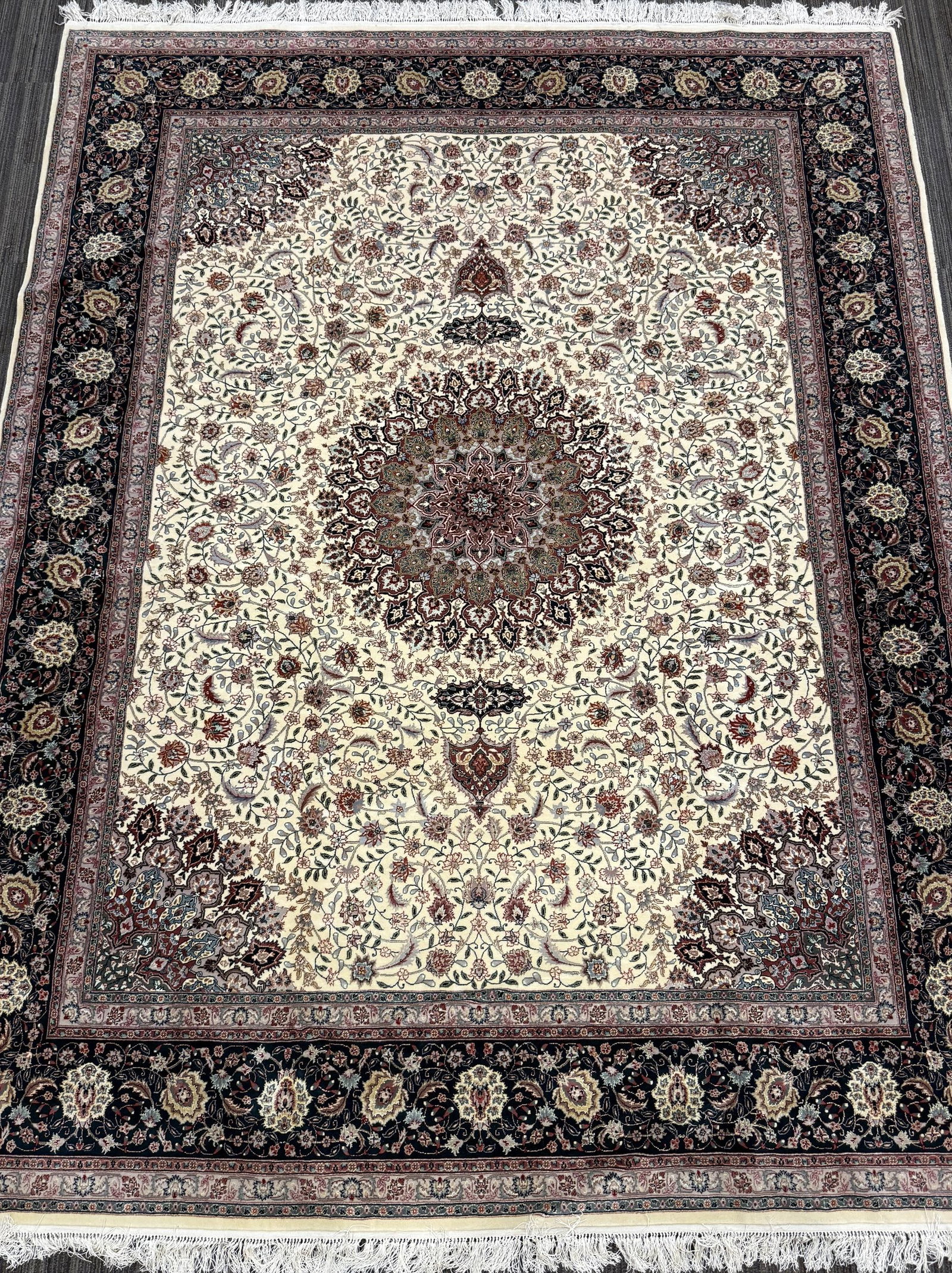 VINTAGE ORIENTAL ROOM SIZE RUG.: A vintage Persian Tabriz carpet, having a large central floral medallion on an ivory field densely decorated with scrolling vines, palmettes and flowering sprays in muted rose, burgundy, green, blue a