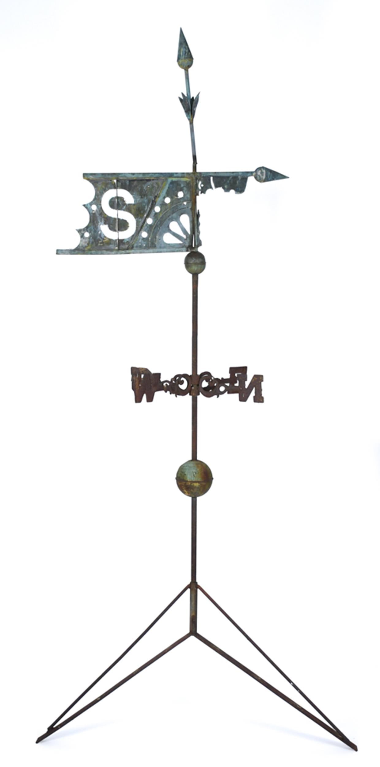 19TH C. BANNER WEATHERVANE WITH DIRECTIONALS.: A 19th C. copper banner form weathervane, reticulated geometric motifs with the initial ‘S’. Includes iron roof mounted display rod and cast iron directionals. Vane 32”W. 96”H