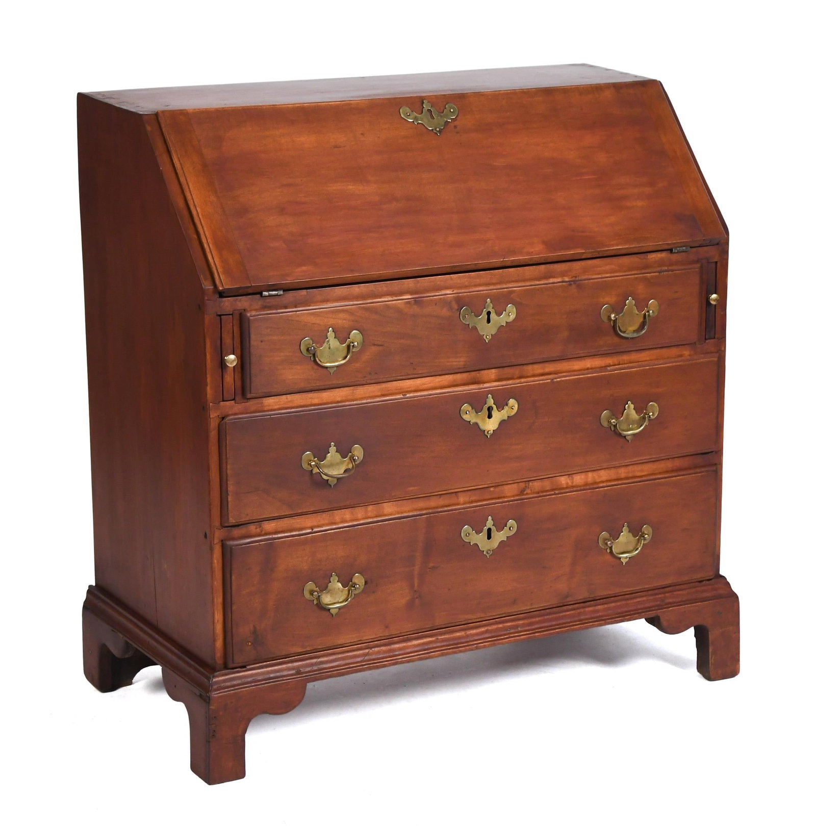 18TH C. CHILD’S SIZE MAPLE SLANT LID DESK.: A ca. 1780 New England red stained maple dovetailed child size Chippendale slant lid desk, with a hinged lid opens to reveal fitted interior, over three full length drawers with antique brasses, on