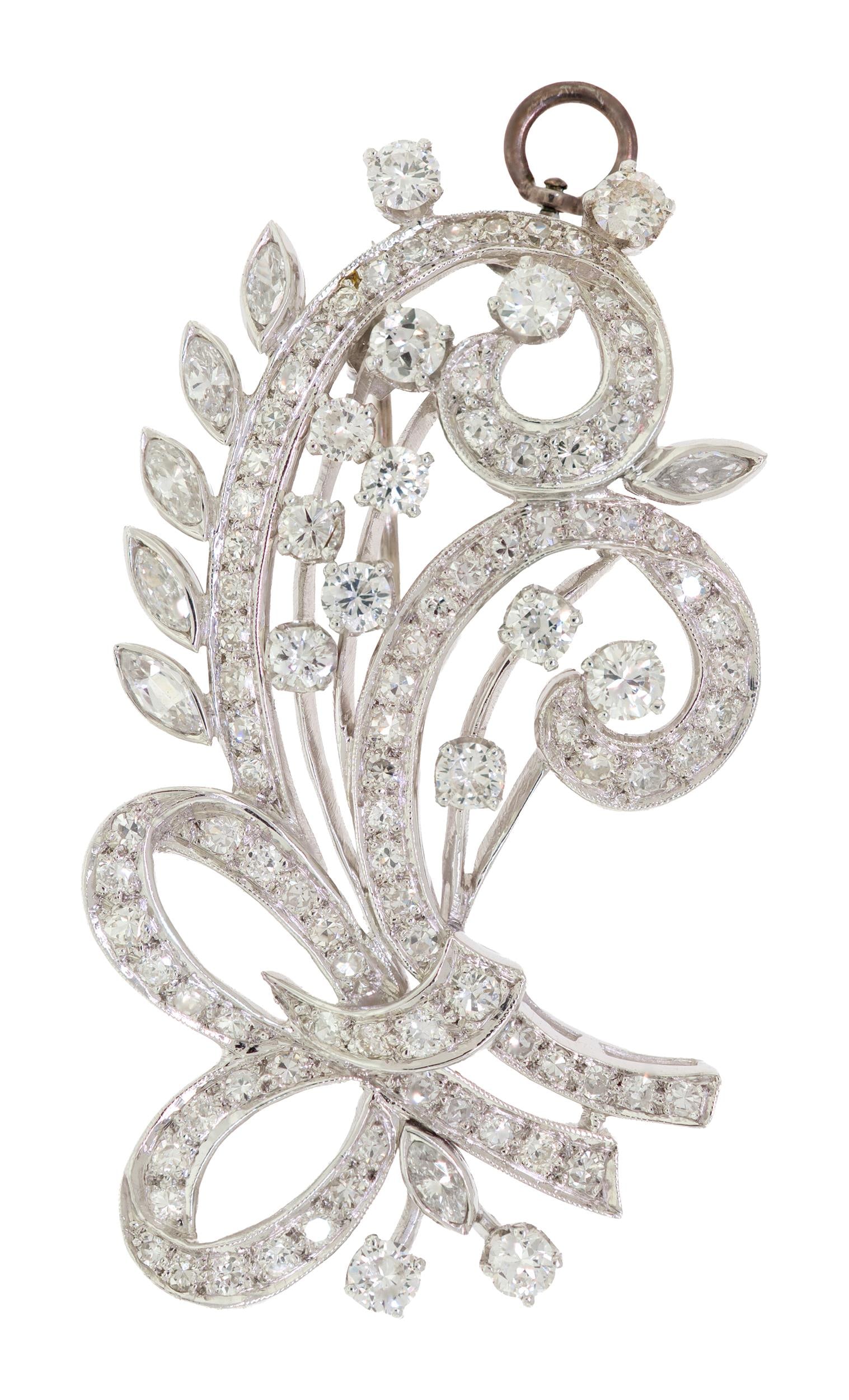 VINTAGE PLATINUM FLORAL SPRAY DIAMOND PIN/PENDANT.: A vintage, platinum (tested), floral spray pin/pendant, set with approx. 3.0 ct. tw., round brilliant, marquise and single cut round, natural diamonds of G-H-I color and VS clarity, 2 inches long, 18.